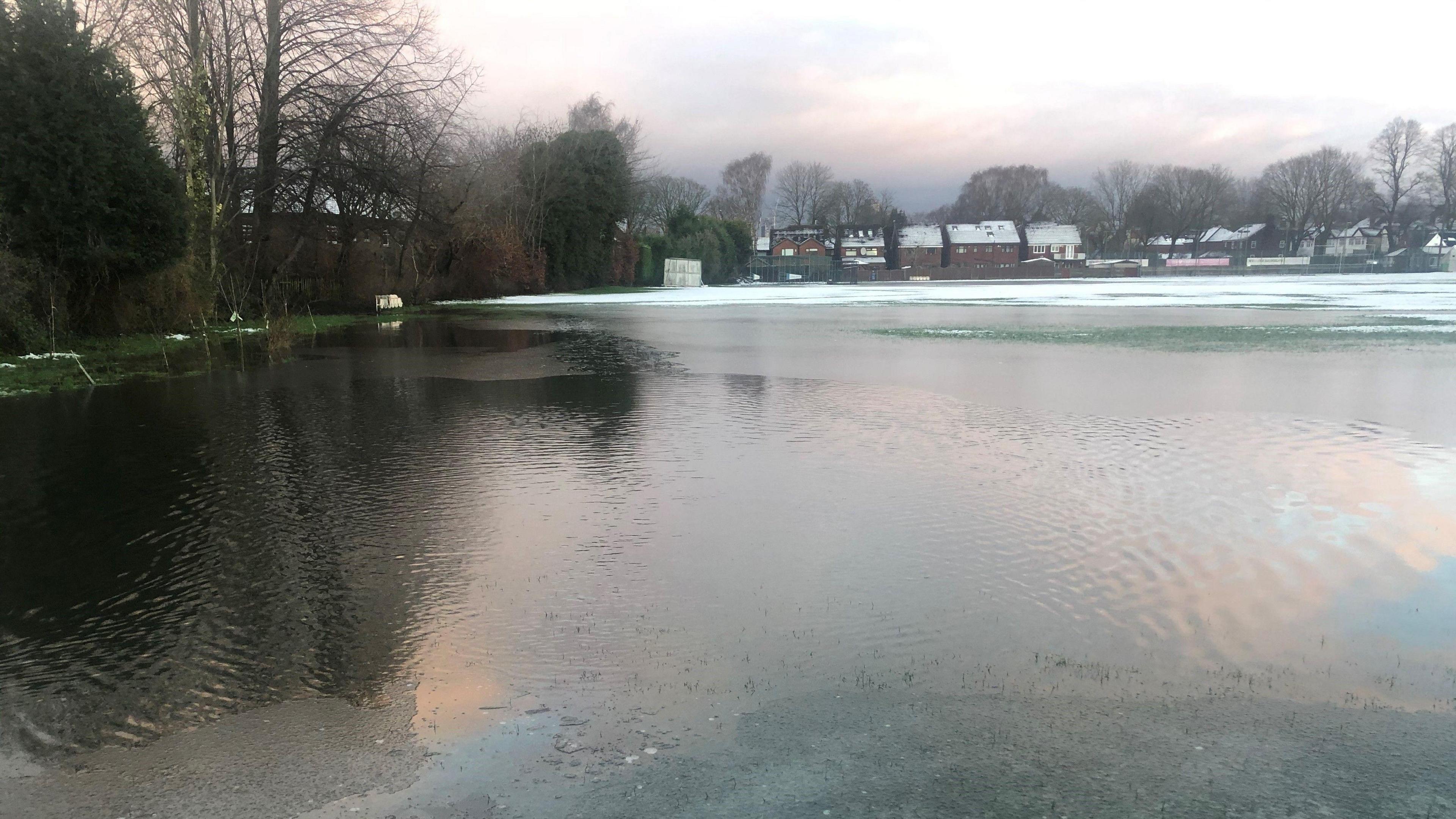 The Whalley Range cricket pitch fully covered by floodwater