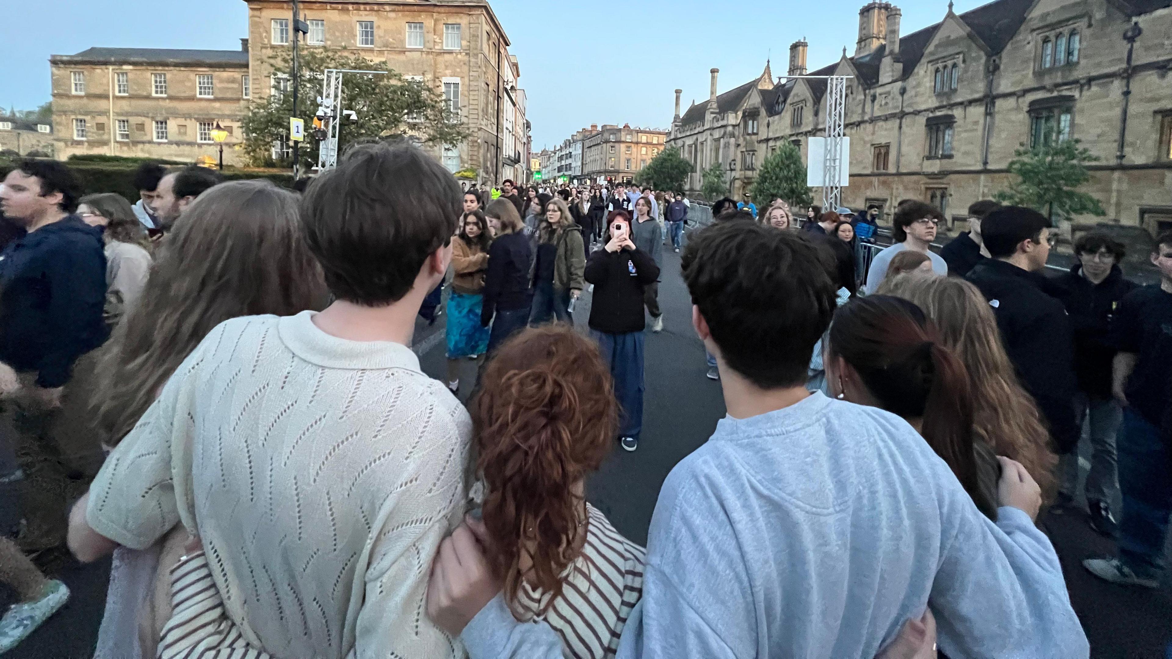 Crowds in the street of Oxford taking photos
