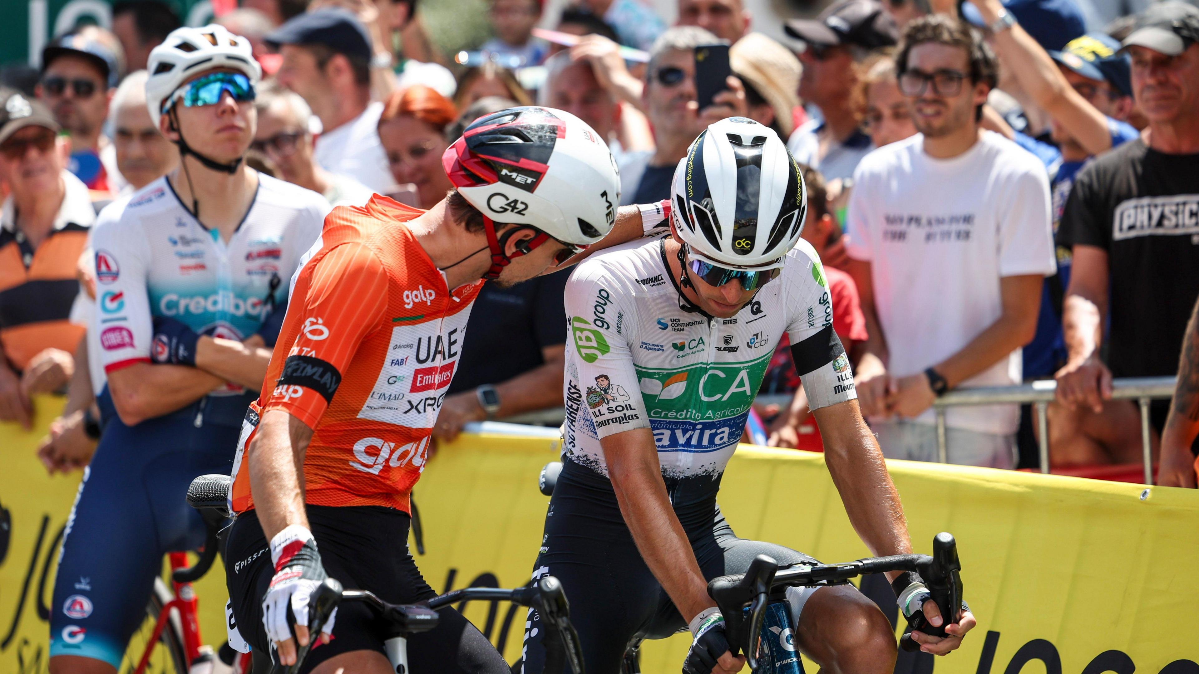 Cyclists console one another