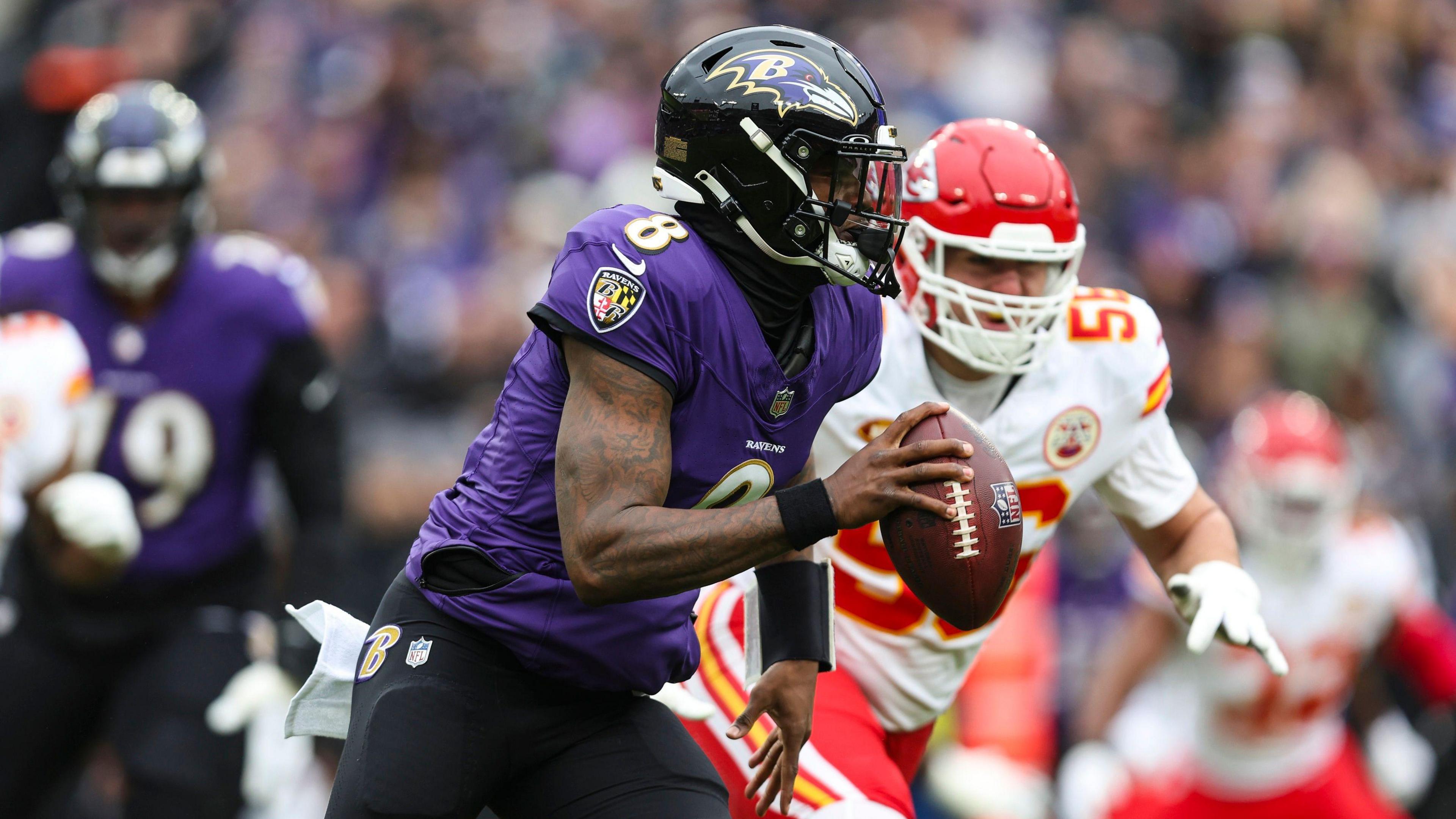 Lamar Jackson of the Baltimore Ravens running with the ball against the Kansas City Chiefs in the NFL