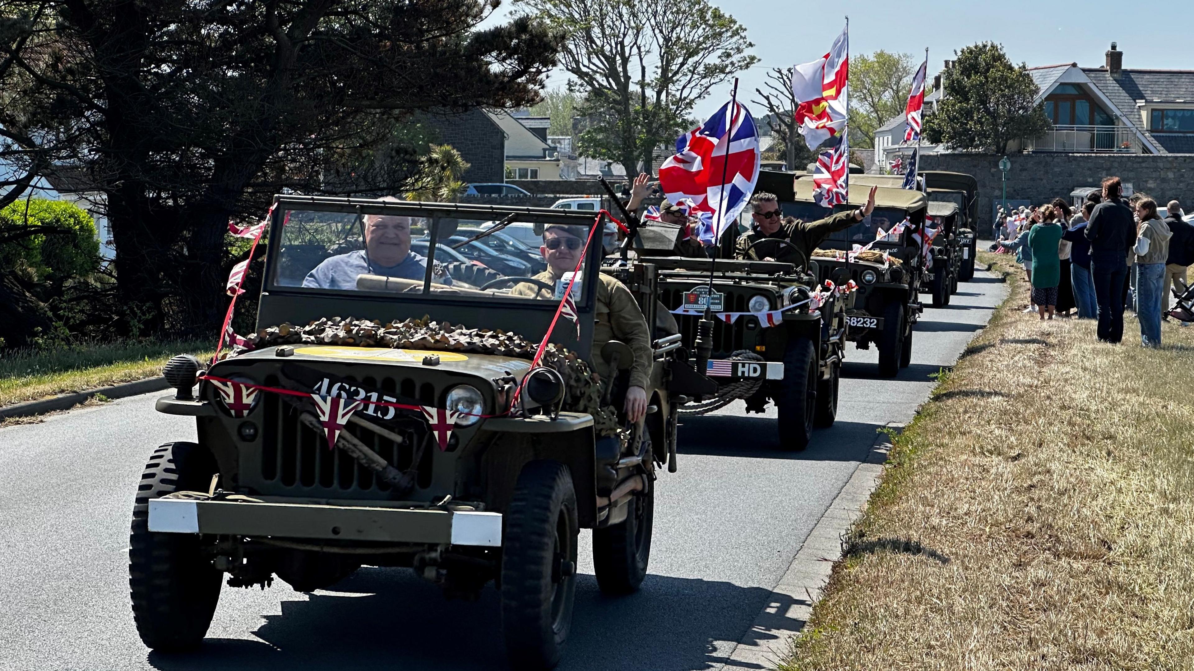 WW2 military vehicles adorned with flags