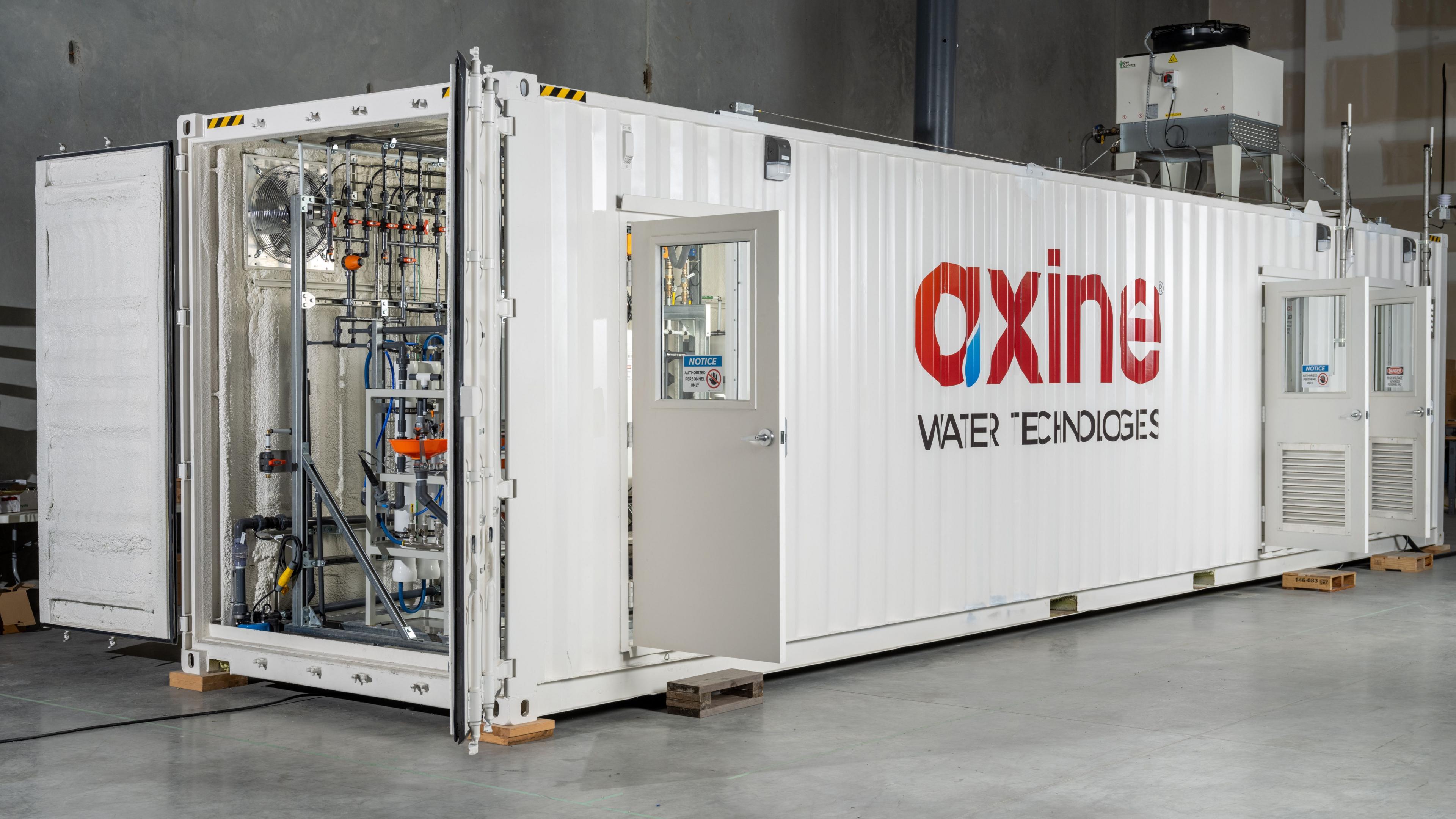 A white container with the doors open - inside you can see some of the Axine water cleaning tech.