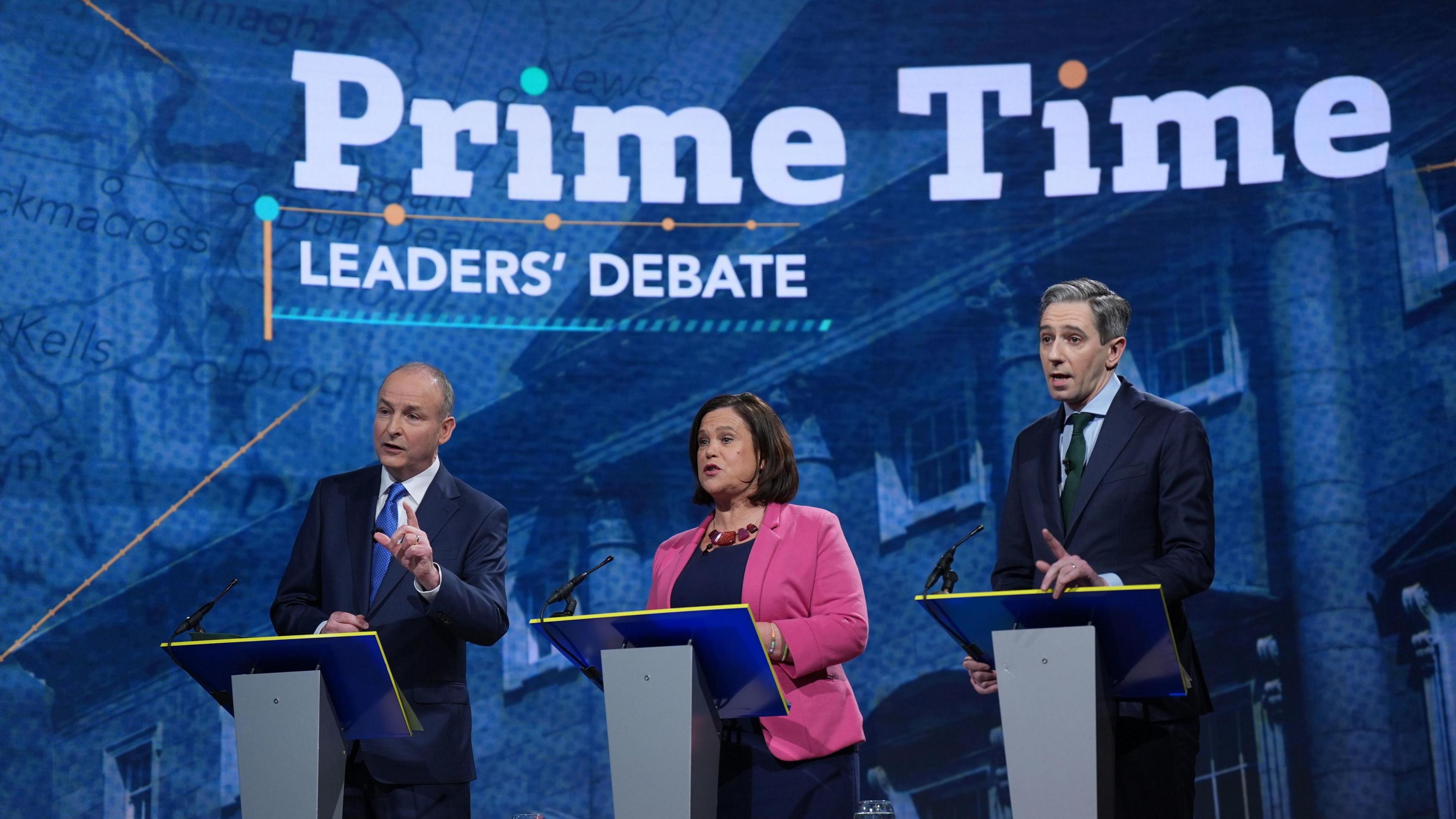 Michael Martin, Mary Lou McDonald and Simon Harris all stand at the podium during the debate