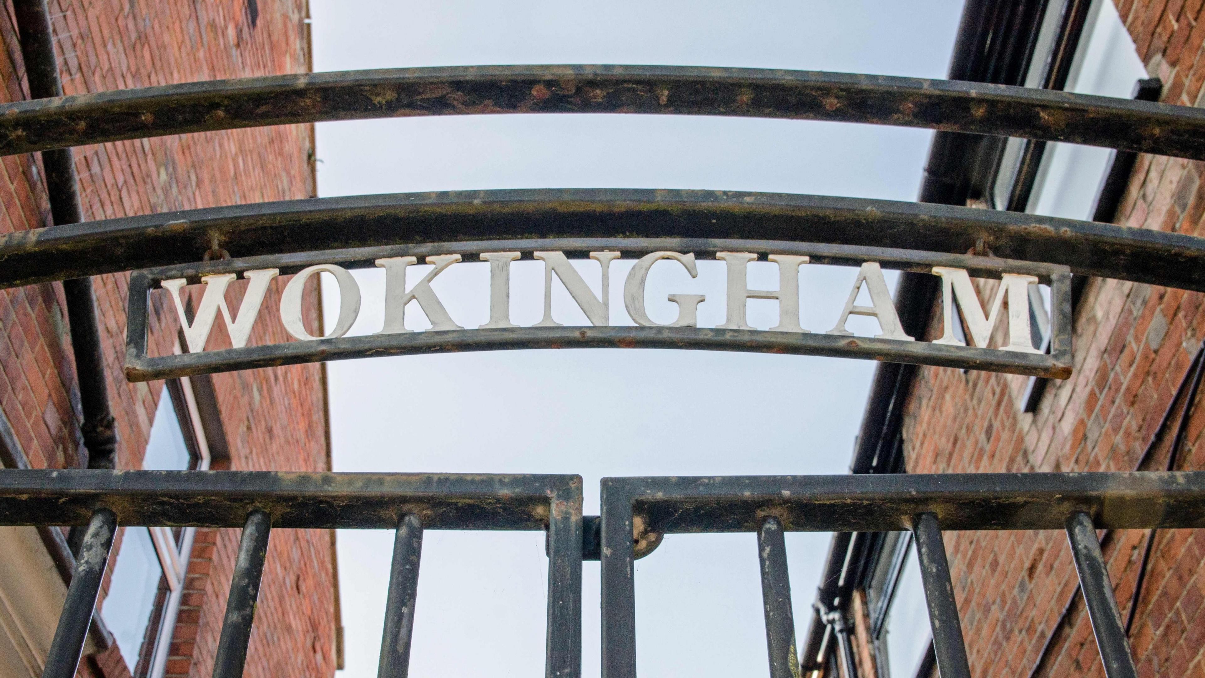 An iron gate with the town name of Wokingham, Berkshire.