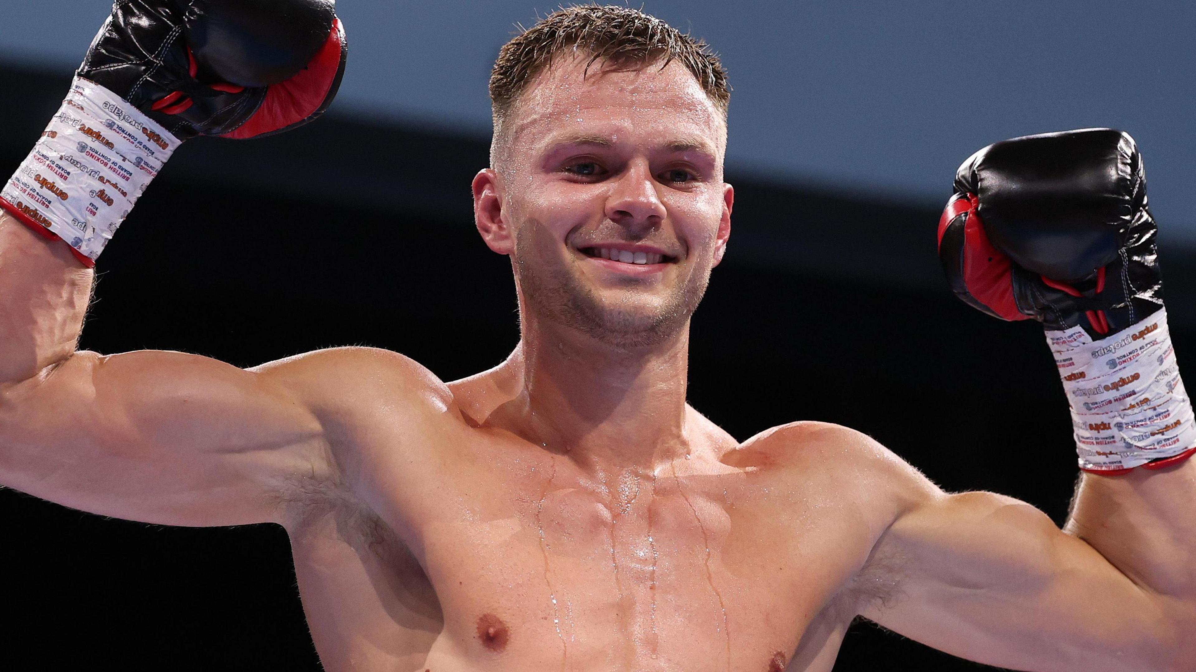 Lewis Richardson pictured after the fight, holding his arms aloft