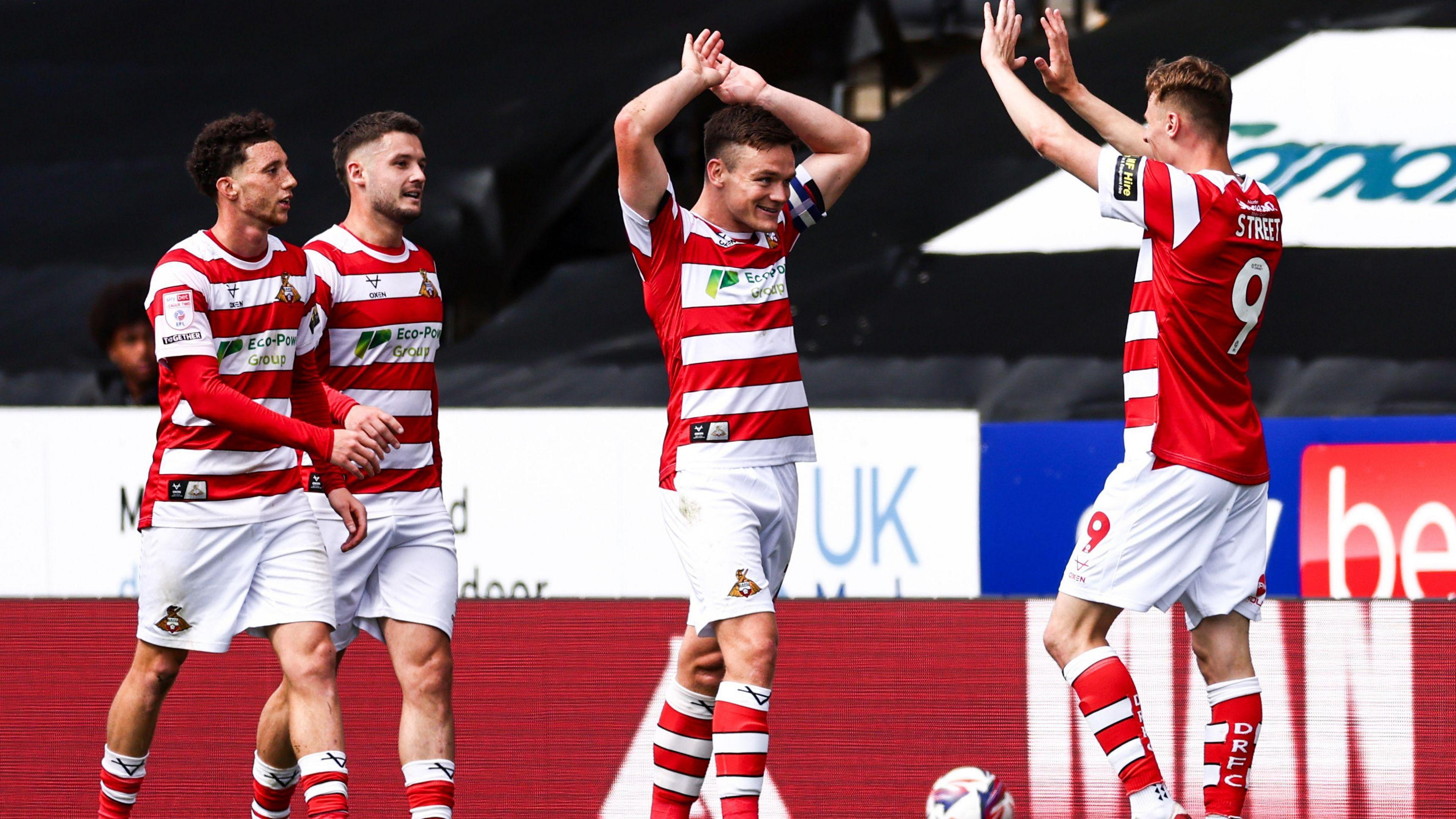 Doncaster Rovers players celebrate with goalscorer Rob Street