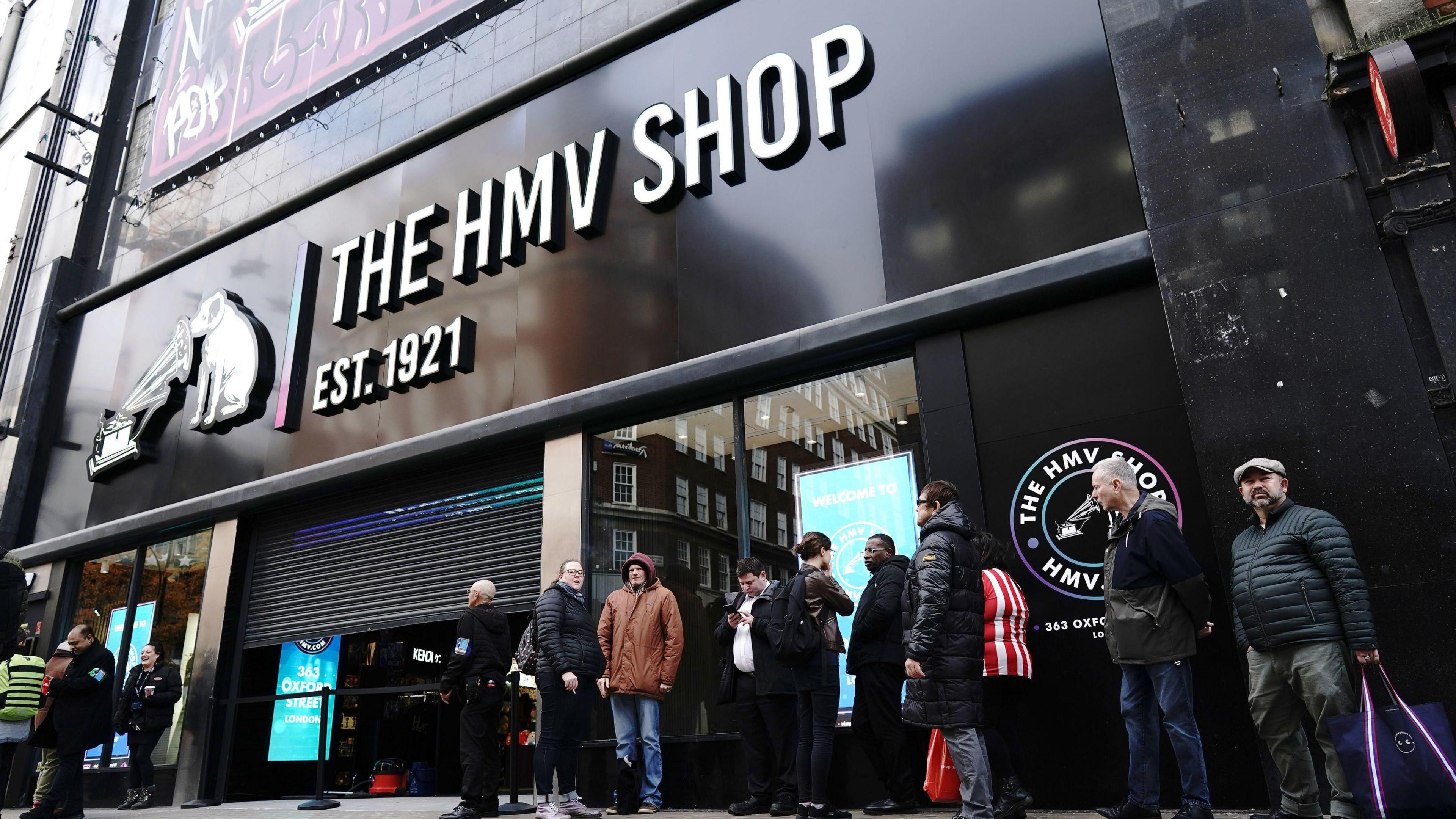 People queue outside the flagship store of HMV on Oxford Street