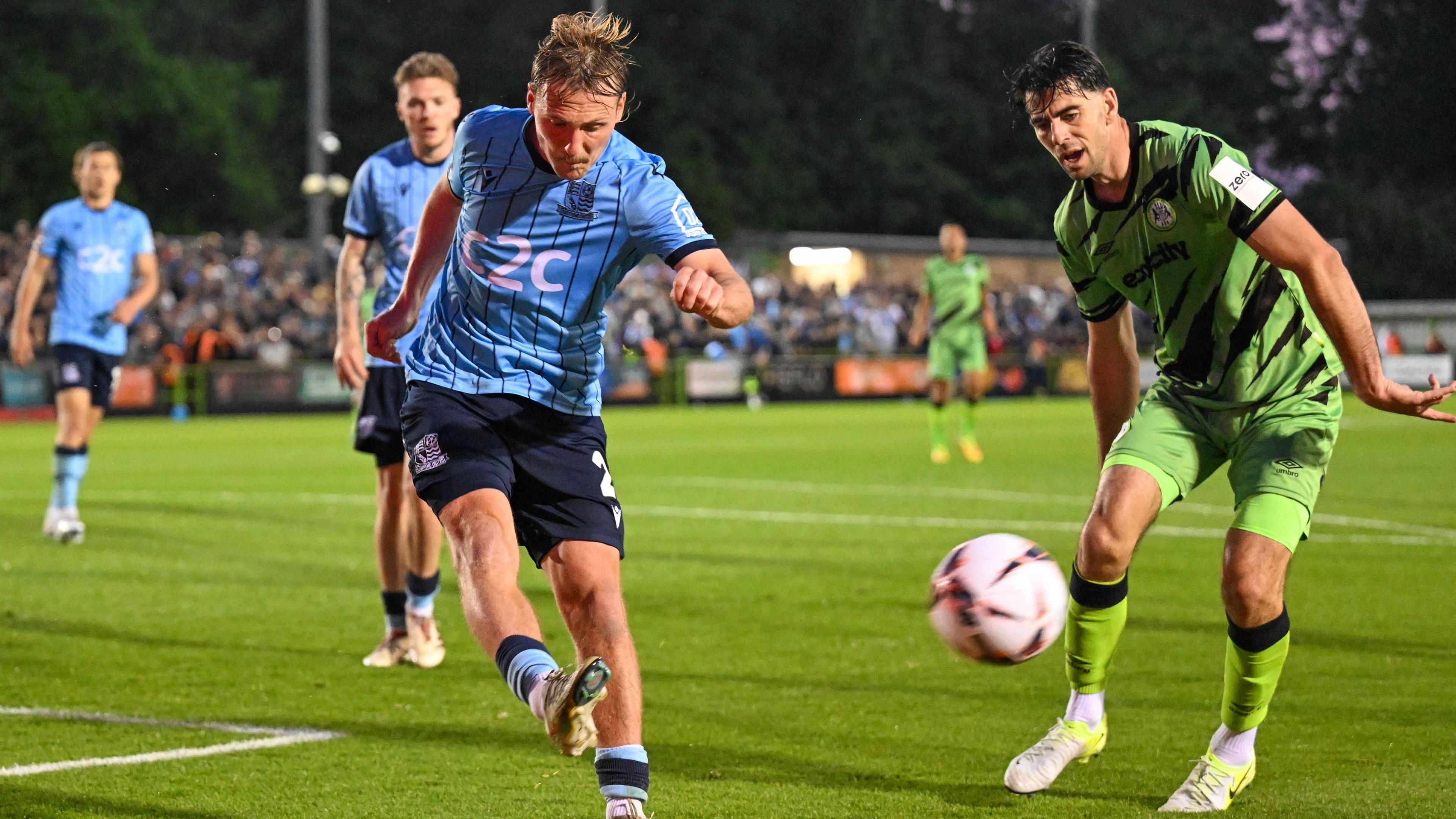 Gus Scott-Morriss clears the ball away from his penalty area as a Forest Green Rovers player closes in during Southend's play-off semi-final