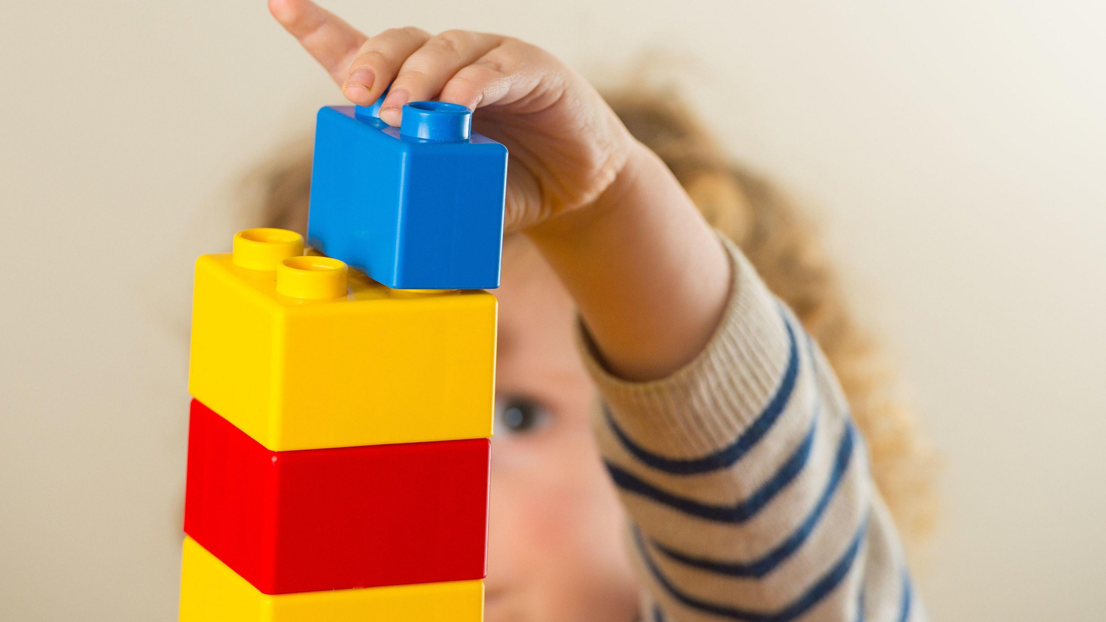 Baby playing with colourful blocks 