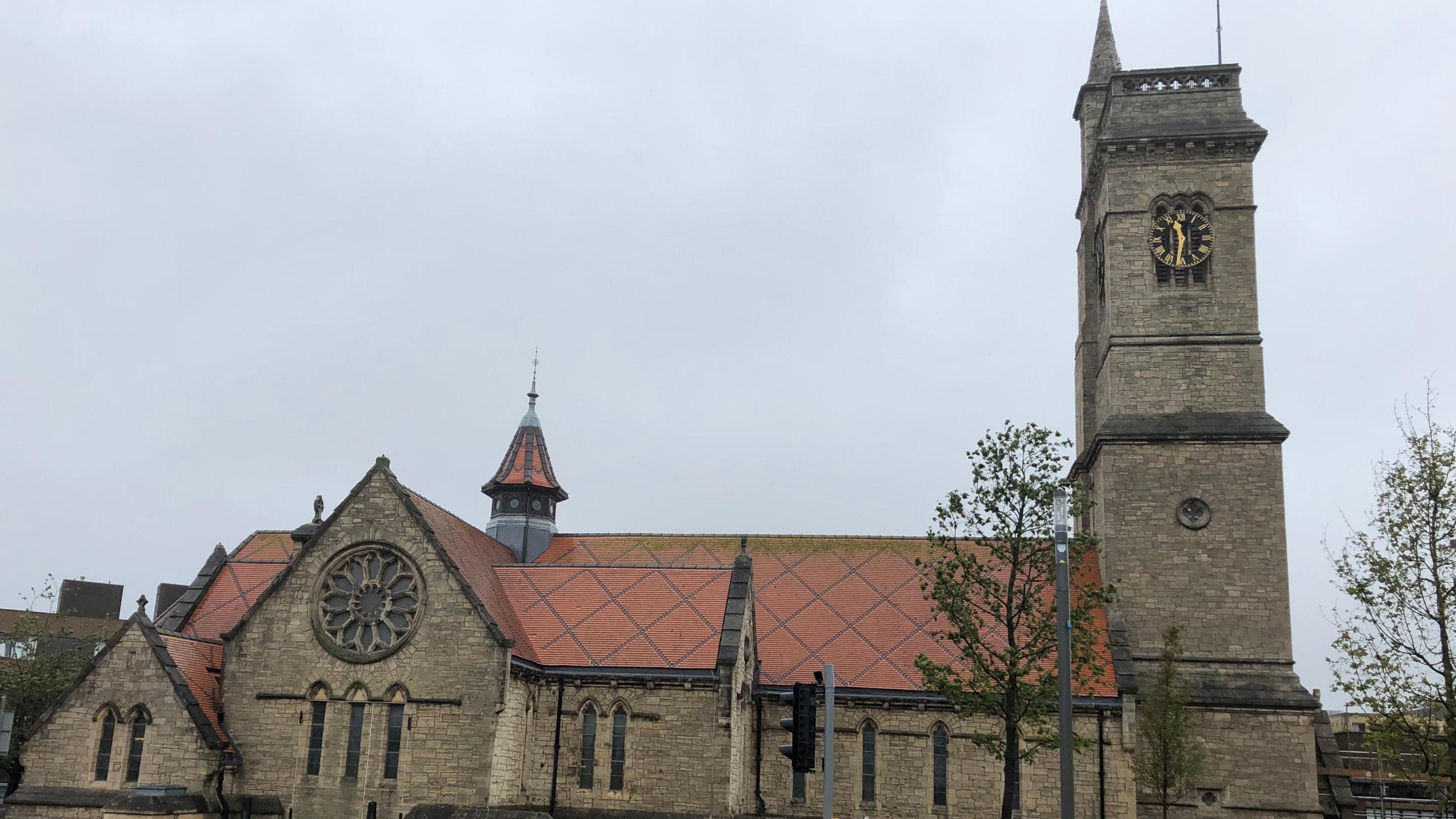 A wide view of the former Christ Church in Hartlepool with the 120 ft high clock tower on the right. A large circular window can be seen on the left side of the building.