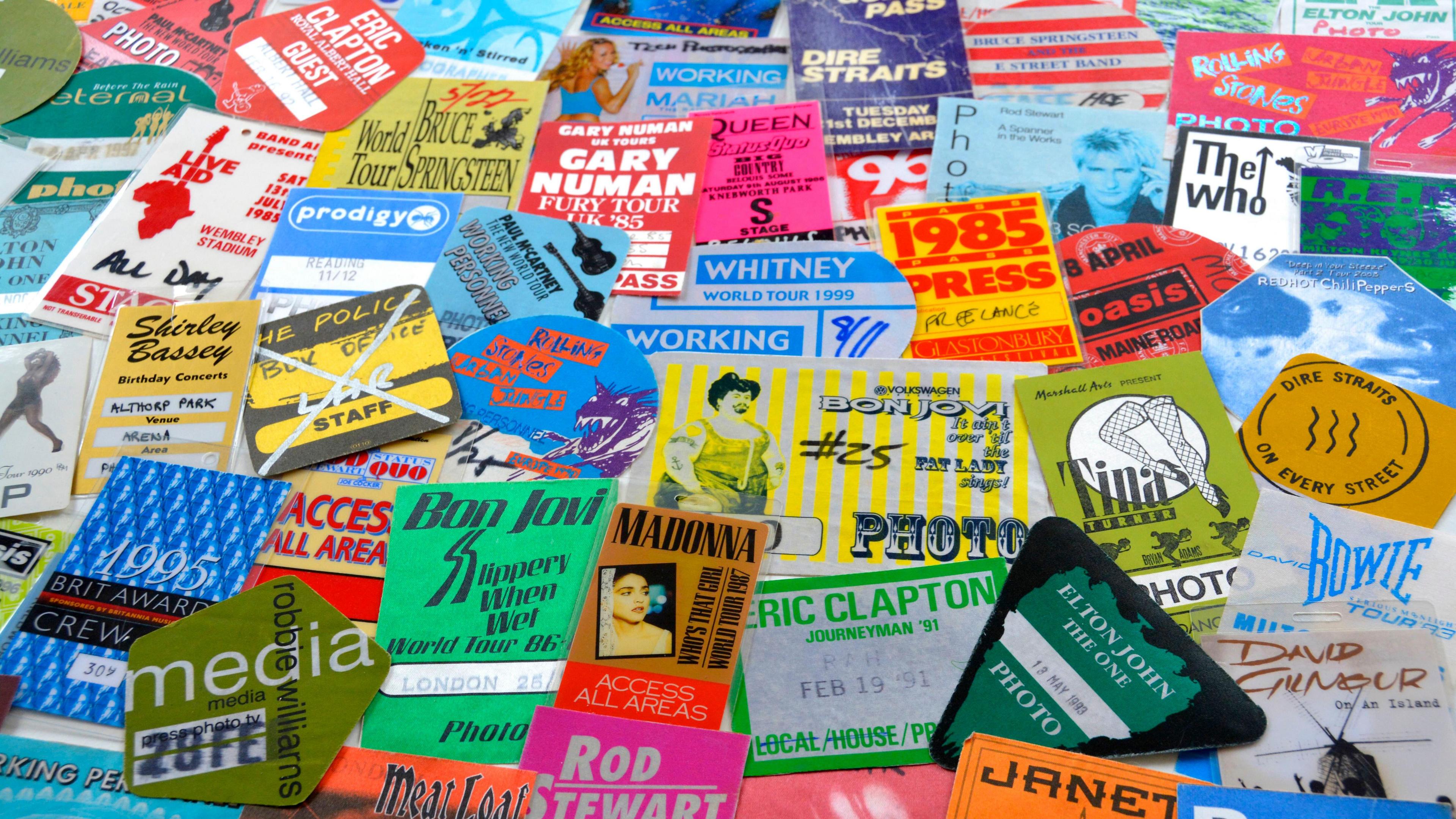 A collection of old, colourful concert tickets and posters. Many famous names are included such as Tina Turner, Madonna, Bon Jovi, Bowie, Shirley Bassey and David Gilmour.