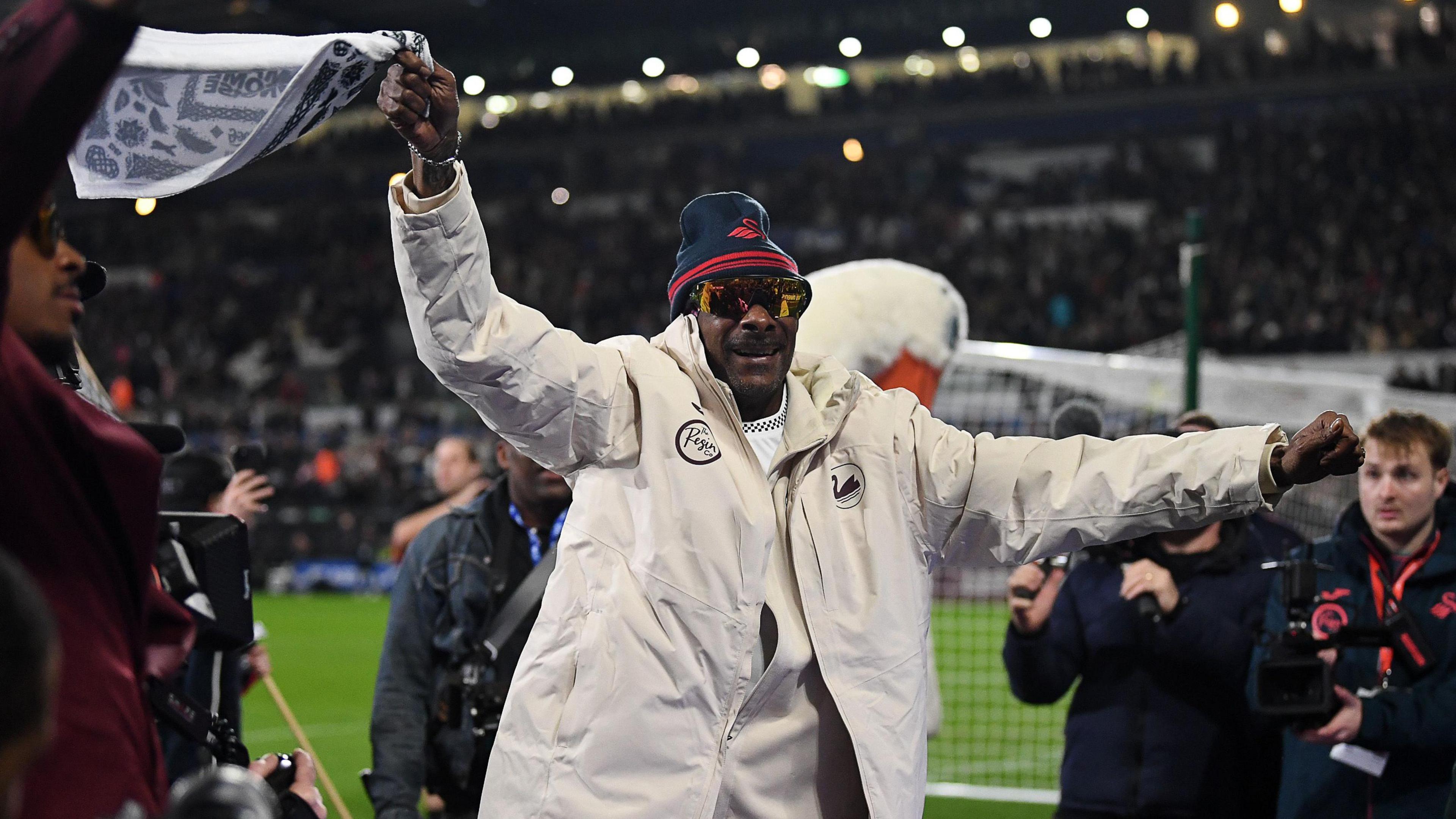 Snoop Dogg waves one of his tea towels at Swansea.com Stadium 