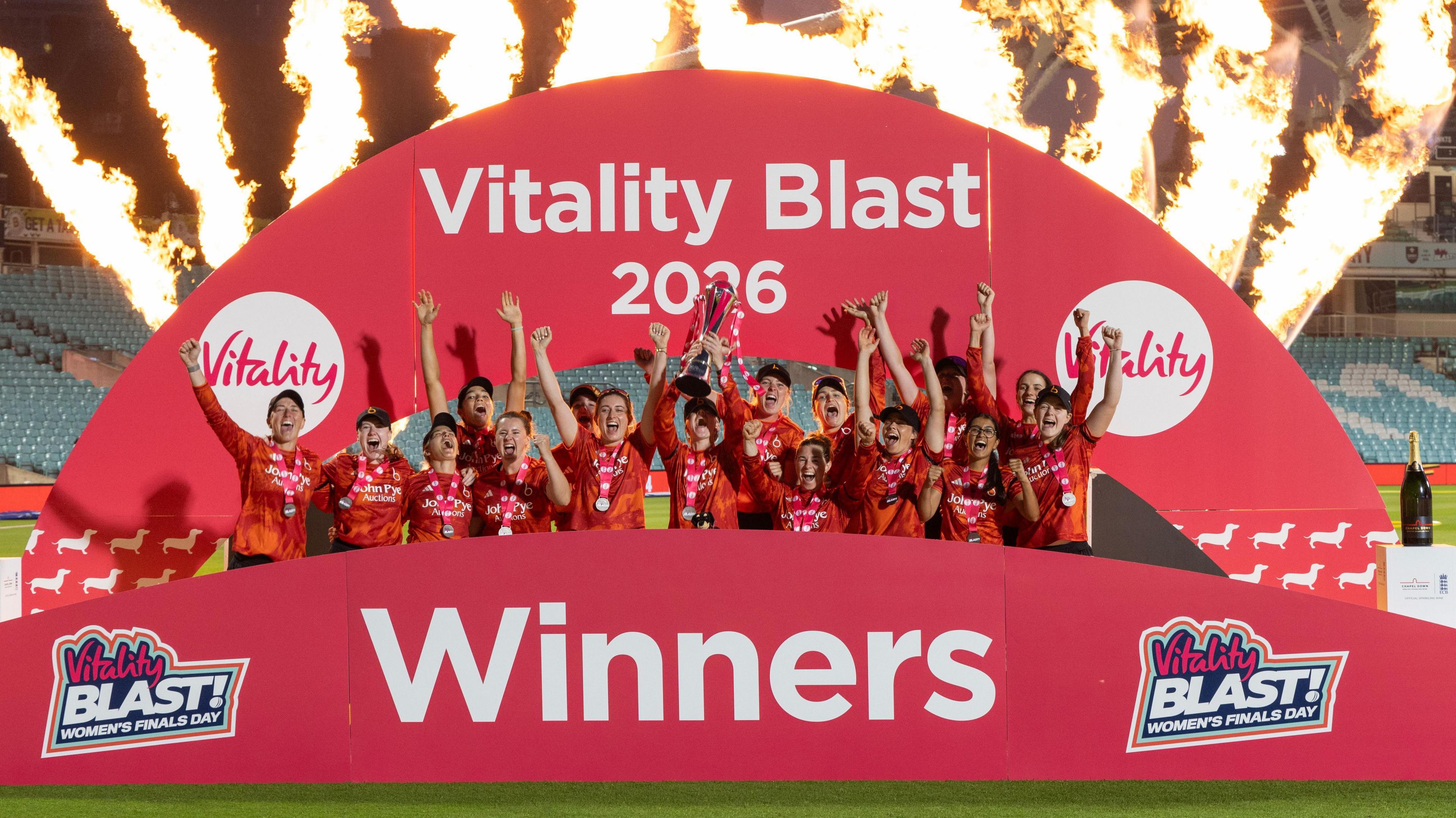 The Blaze team lift the T20 Blast trophy with flames in the background
