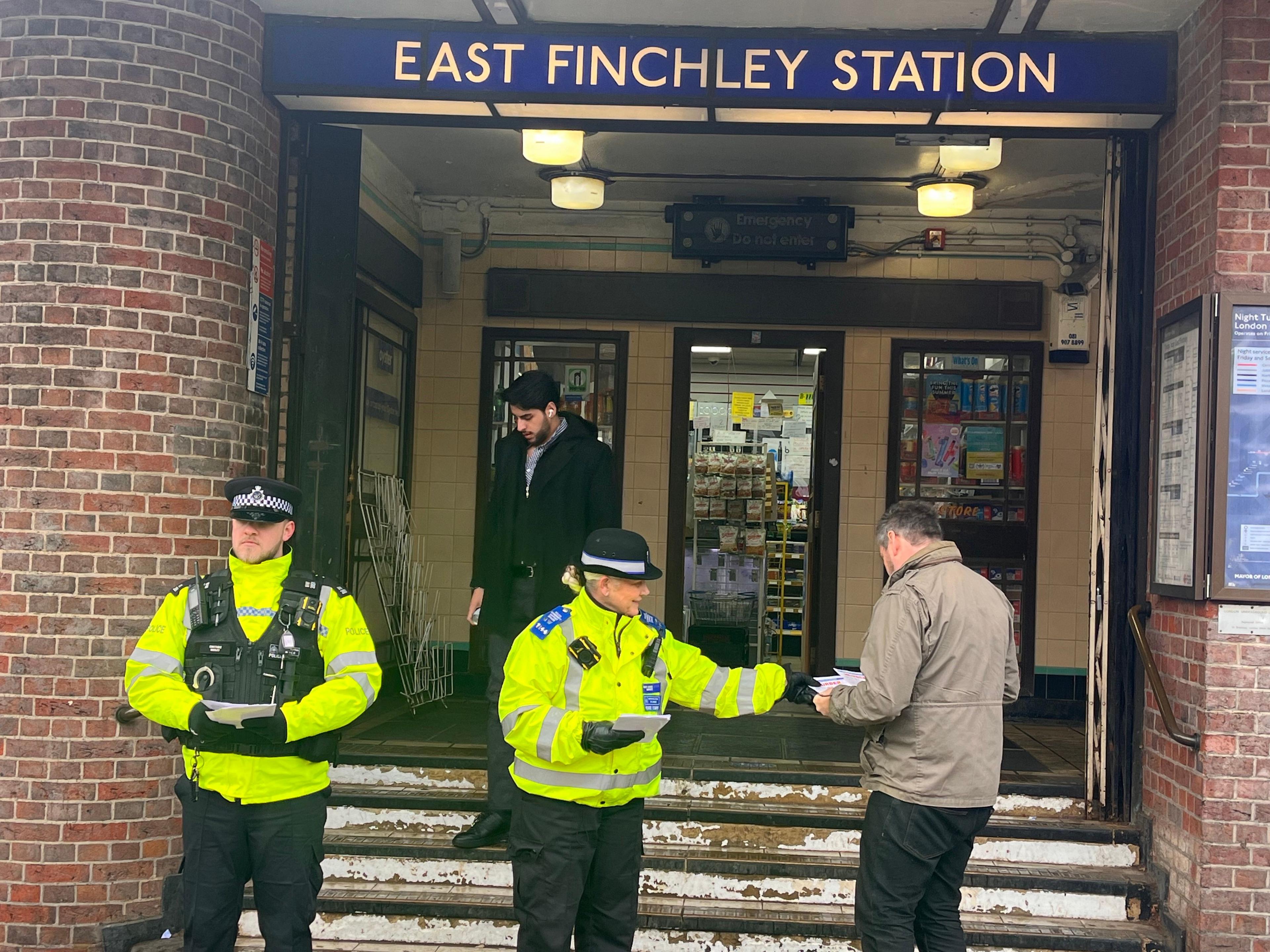 Metropolitan police officers hand out leaflets near where Littler was murdered