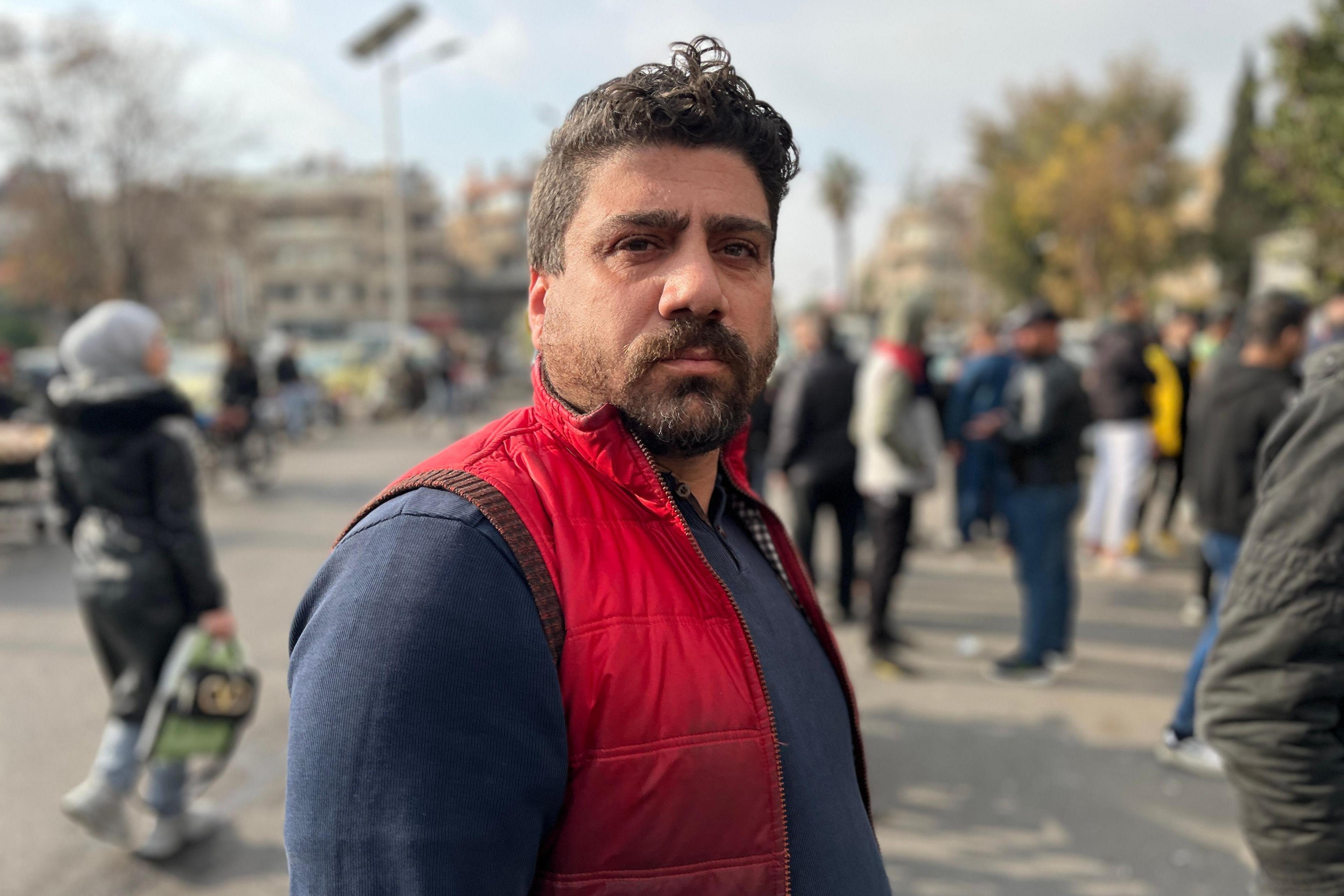 A man wearing a red gilet is pictured in the street