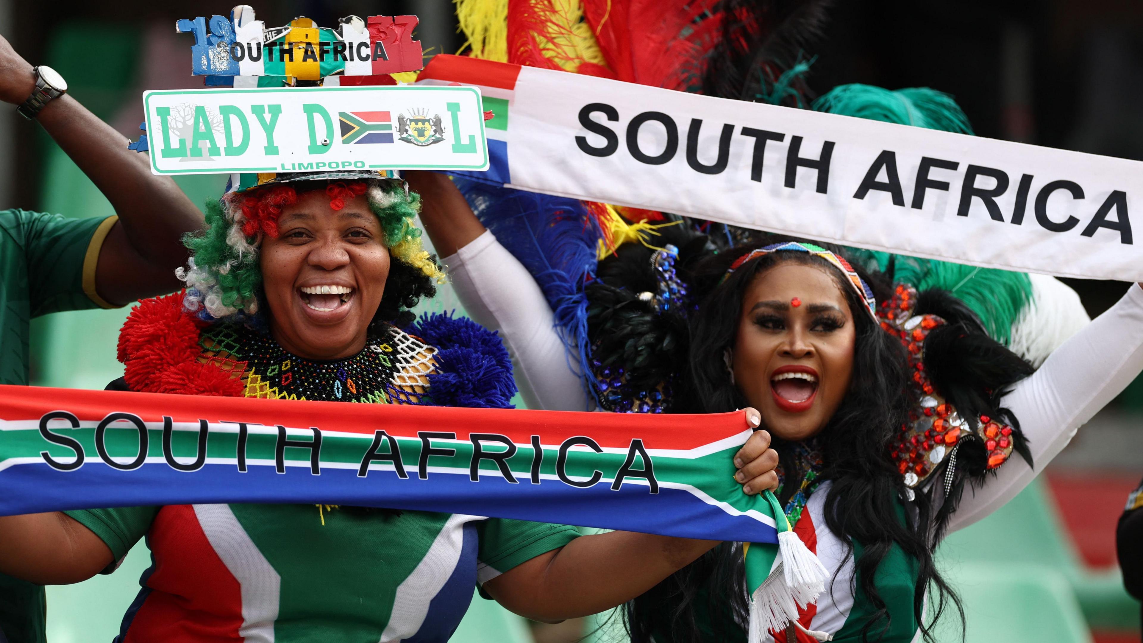 South Africa fans hold up banners and scarves in the national colours
