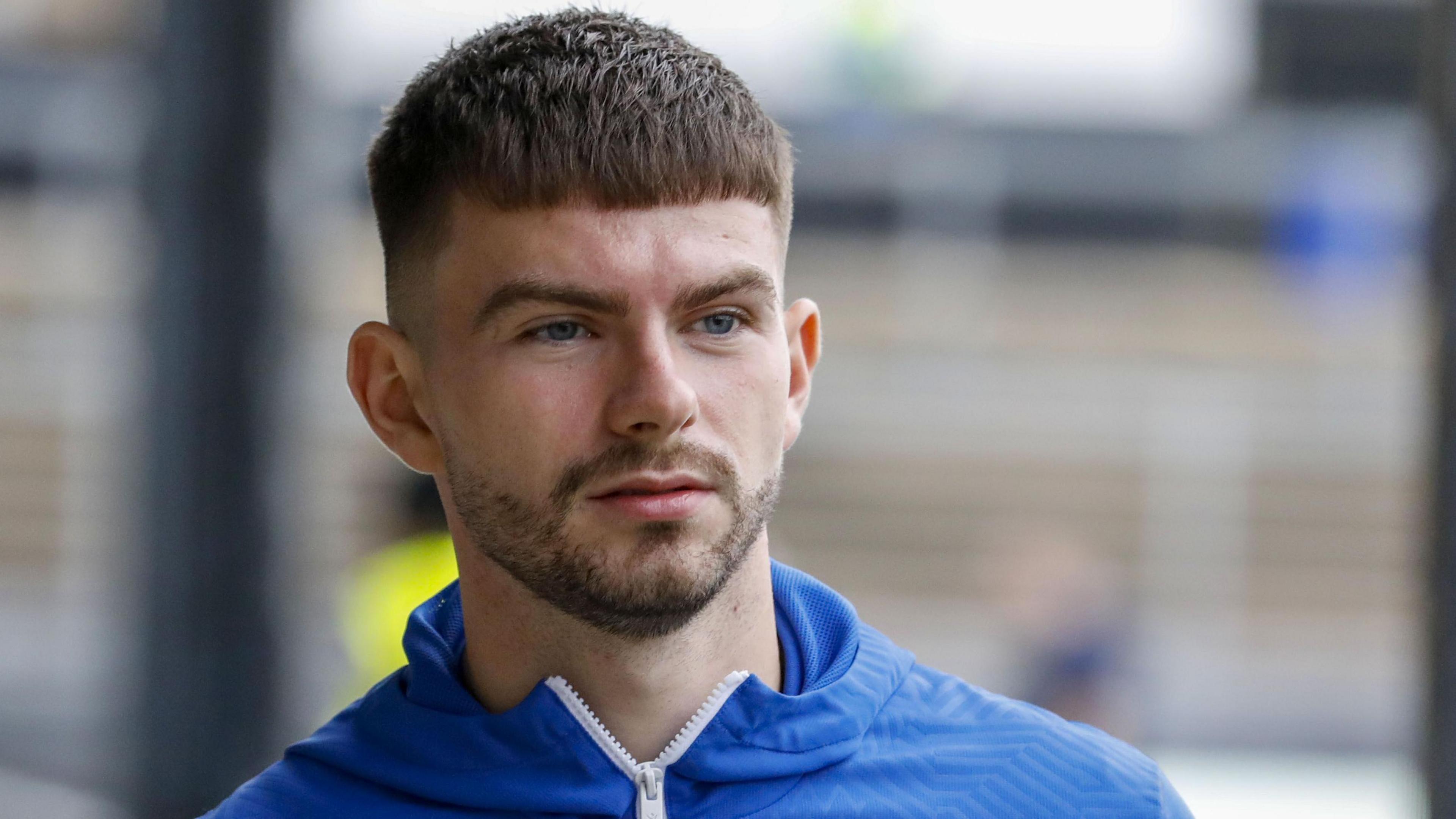 A head shot of Michael Forbes walking along the touchline ahead of a game 