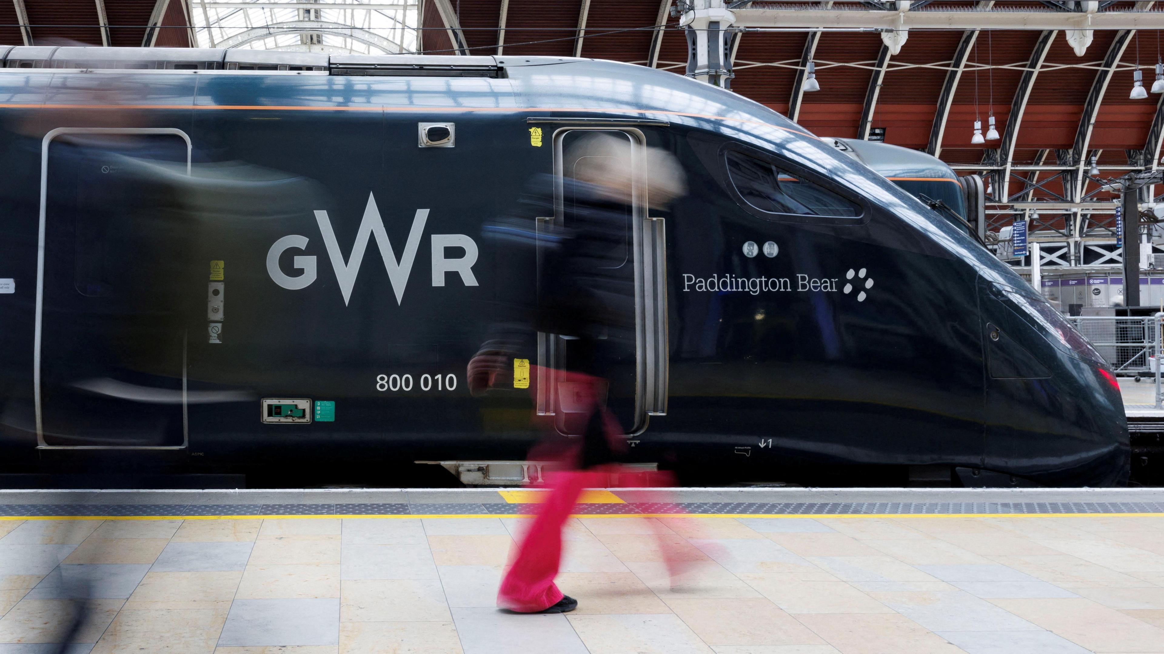 Side shot of a GWR train in London Paddington railway station, bearing the name of the train: "Paddington Bear"..