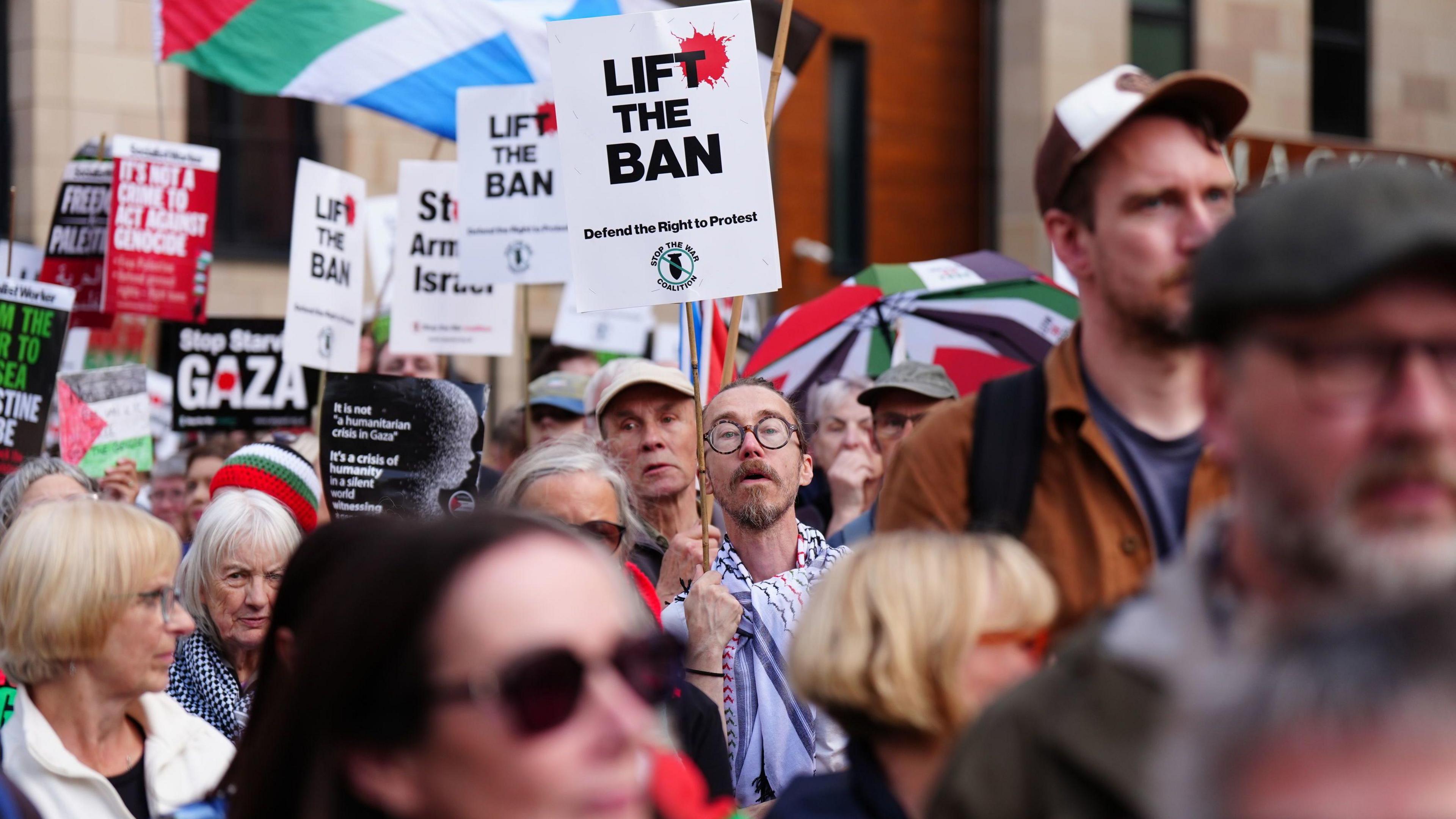 A group of protesters with pro-Palestine placards