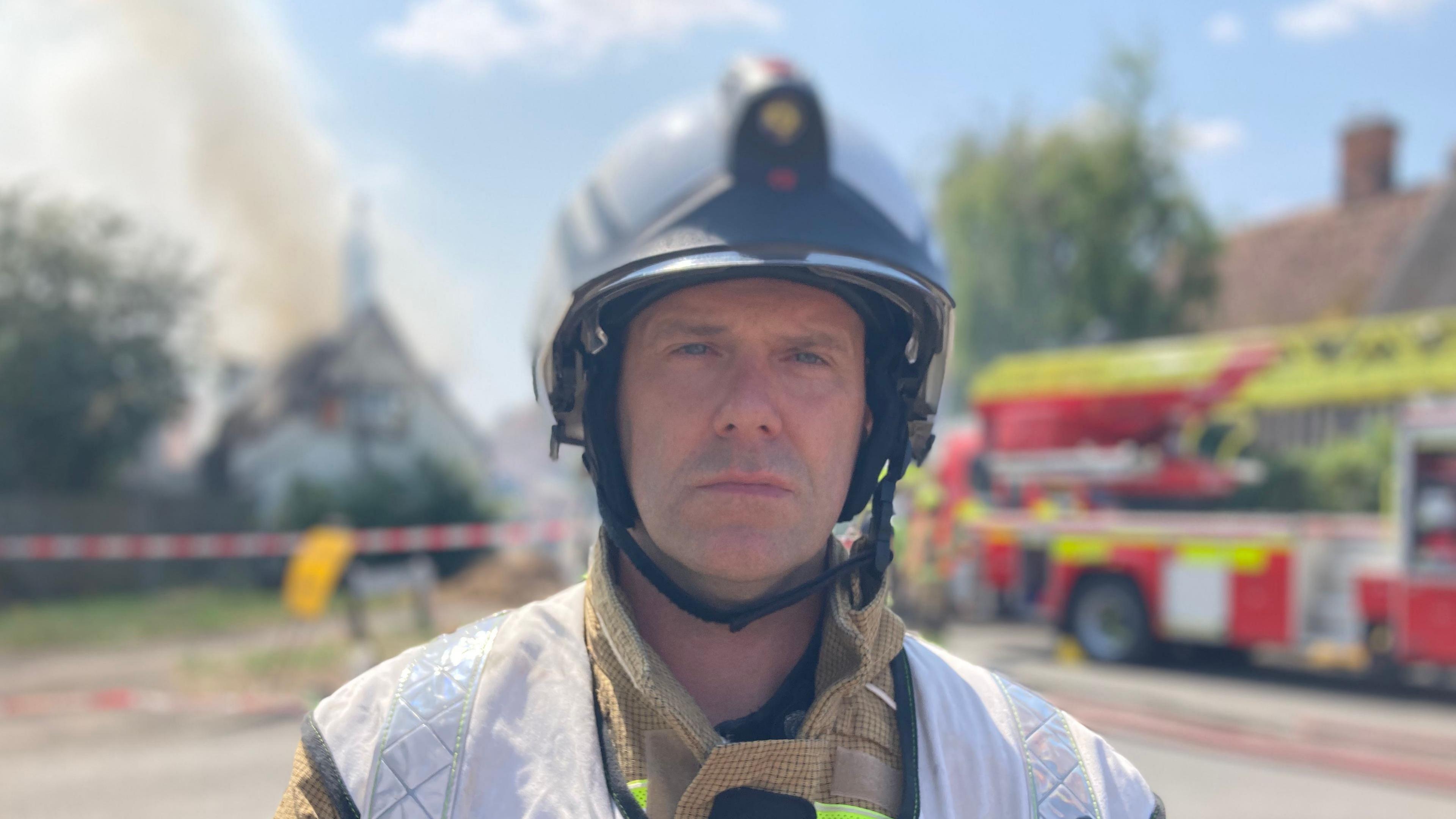 A head-and-shoulders image of a firefighter looking directly into the camera.
