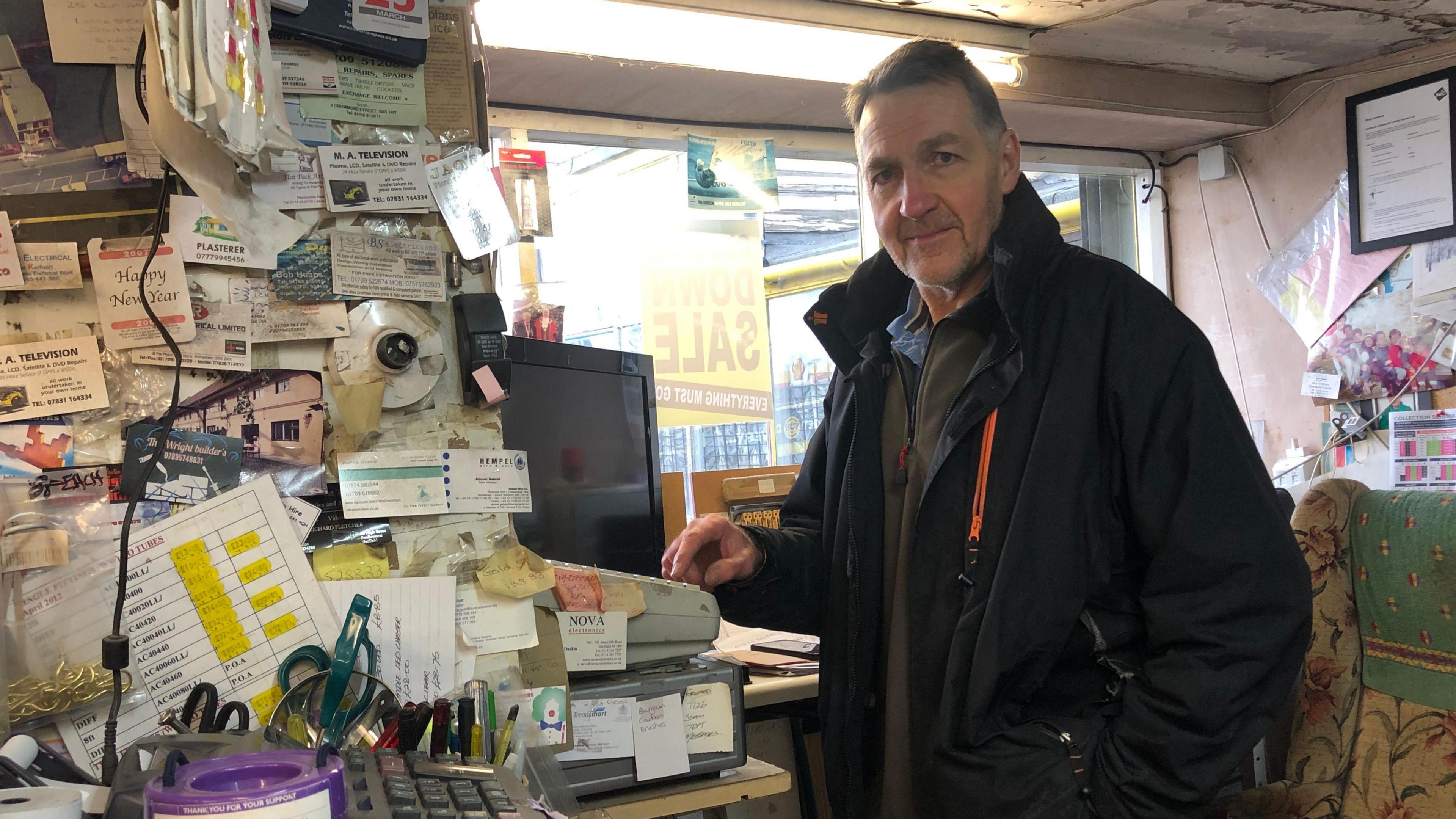 Melvyn Stroughair using the till in the shop