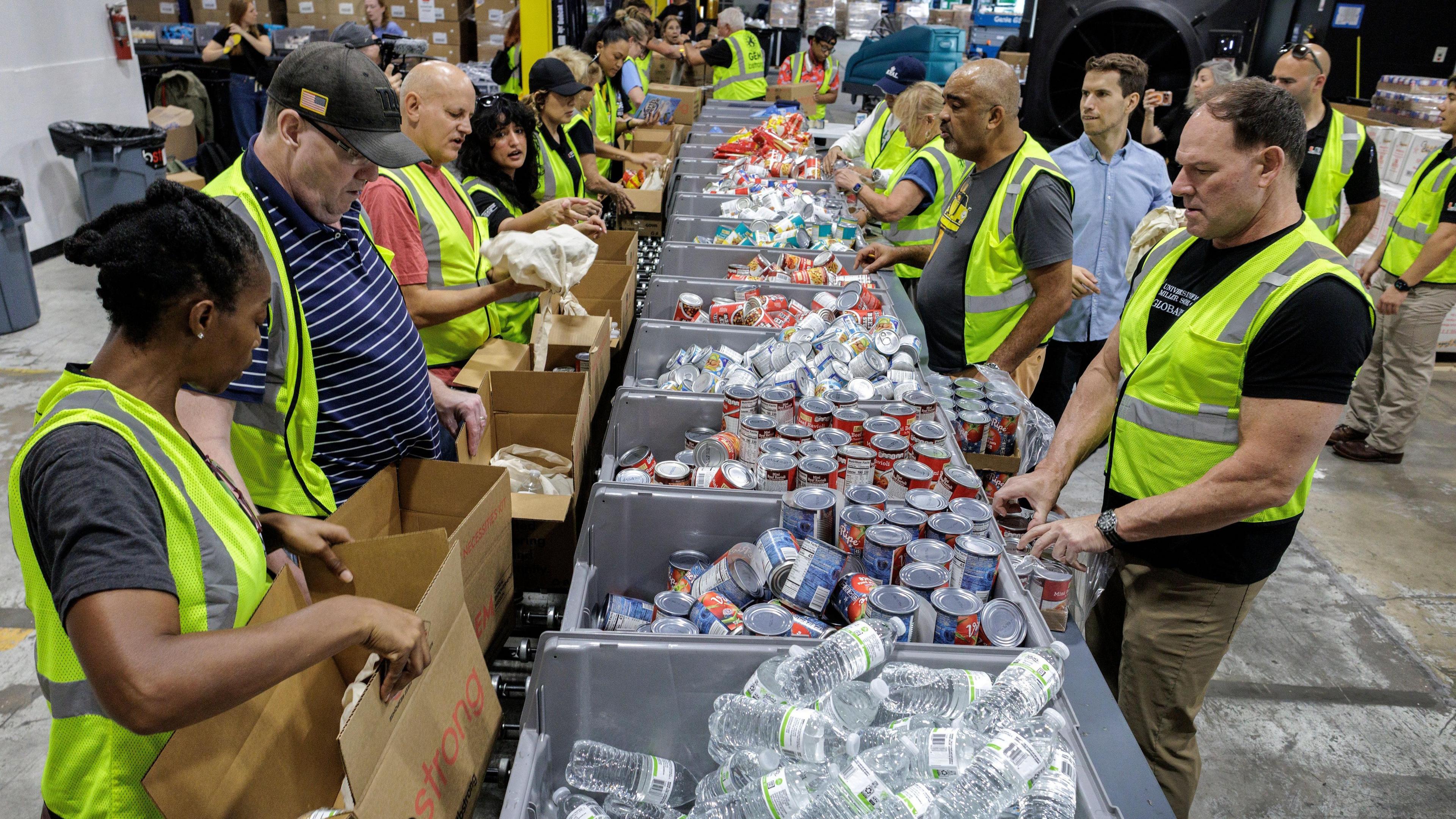 Volunteers in America fill up boxes with food and water to help people affected by the hurricane.