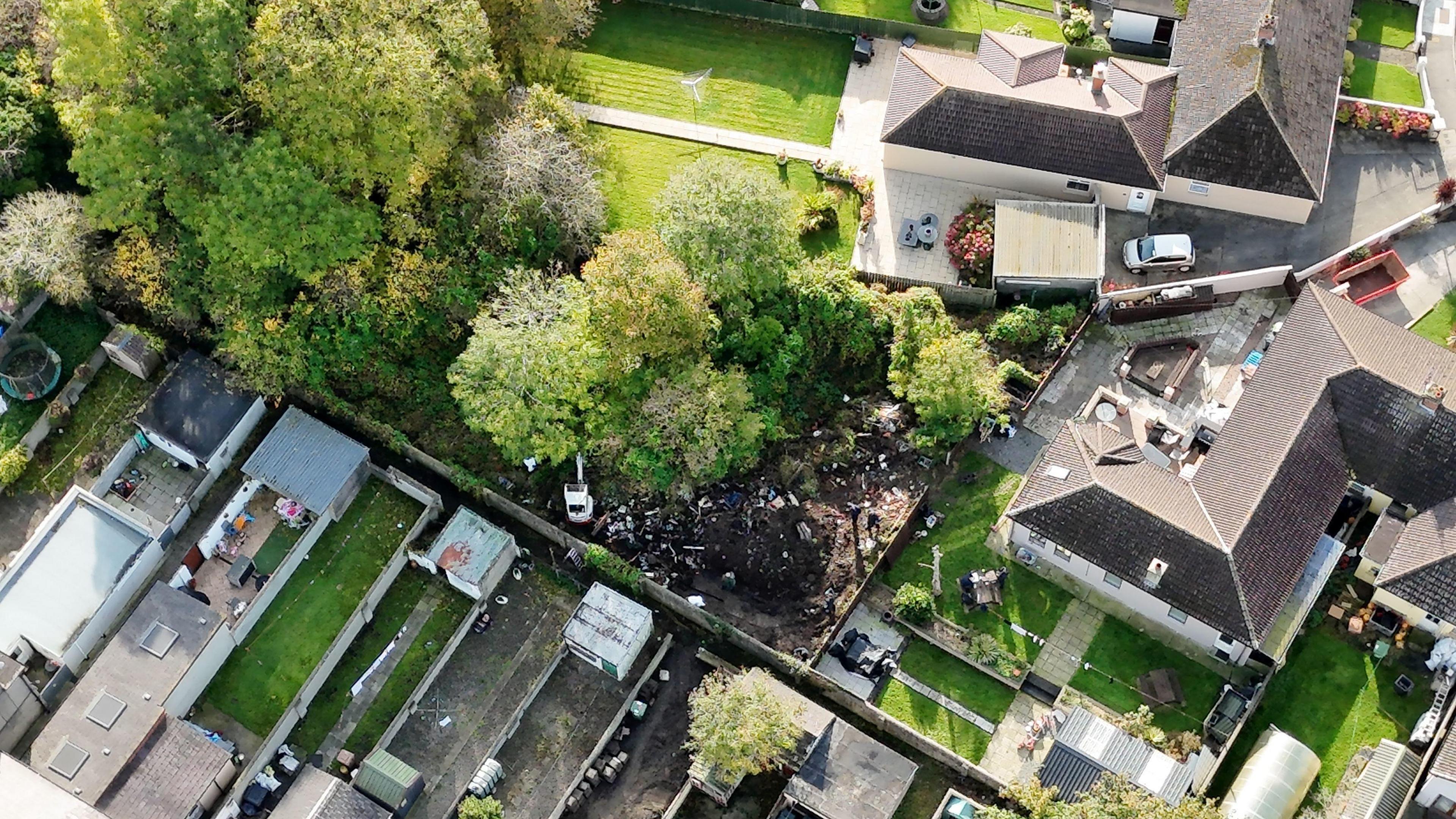 An aerial shot of Kyran's family home. It shows a number of terrace house gardens on the bottom, with a partial dug up garden just behind the fence.