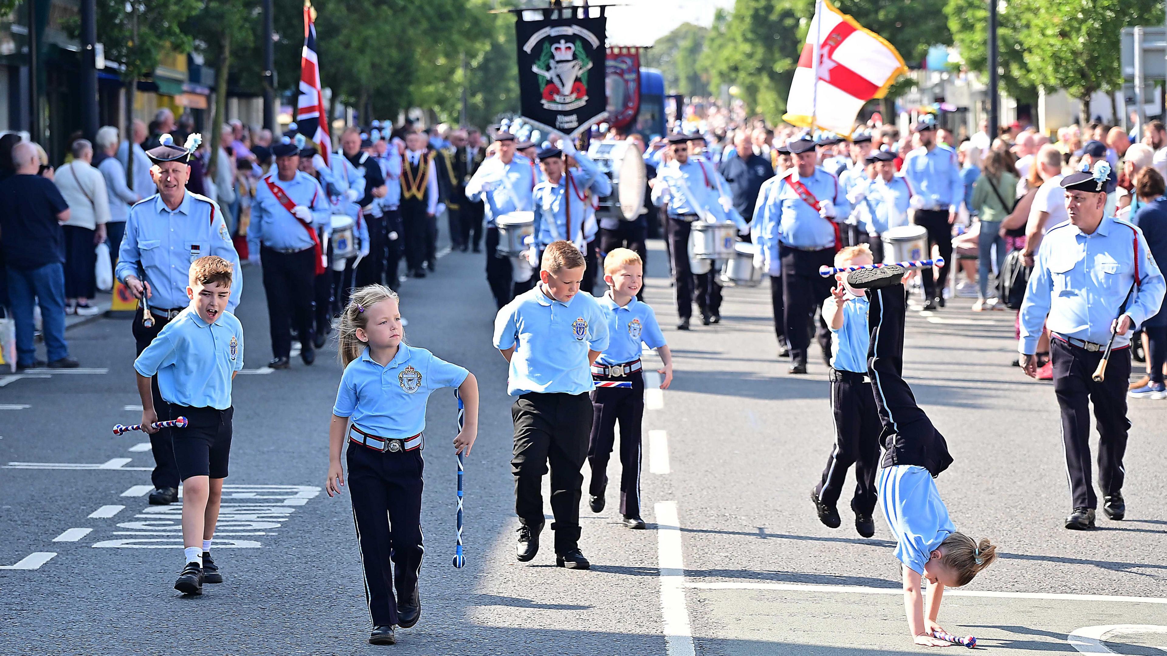 Children march down the road in Holywood during the parade