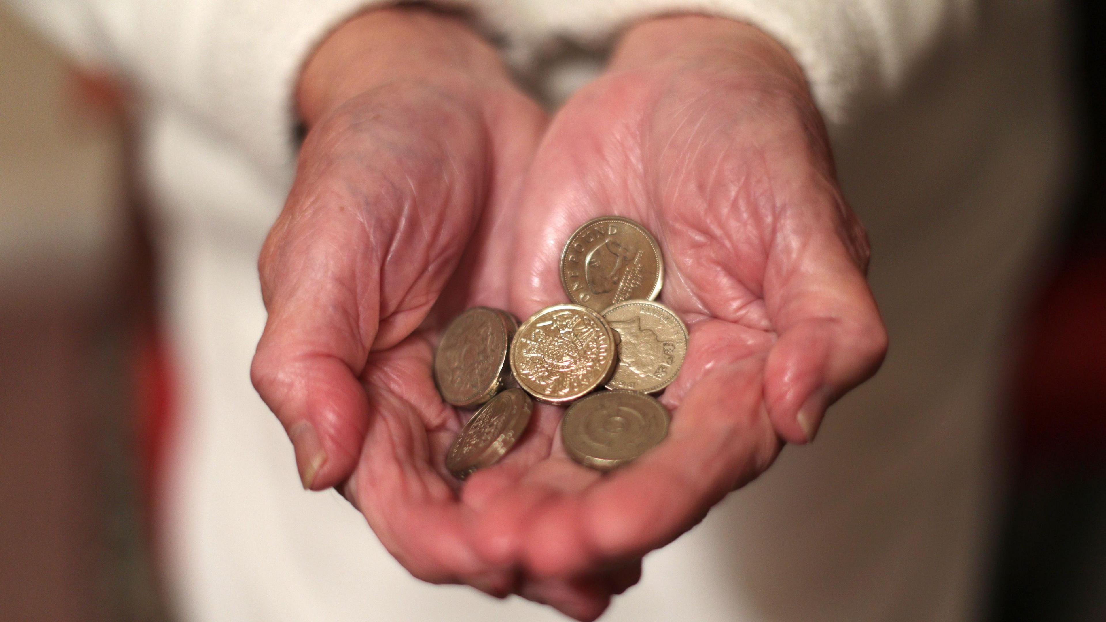 Pensioner holding coins