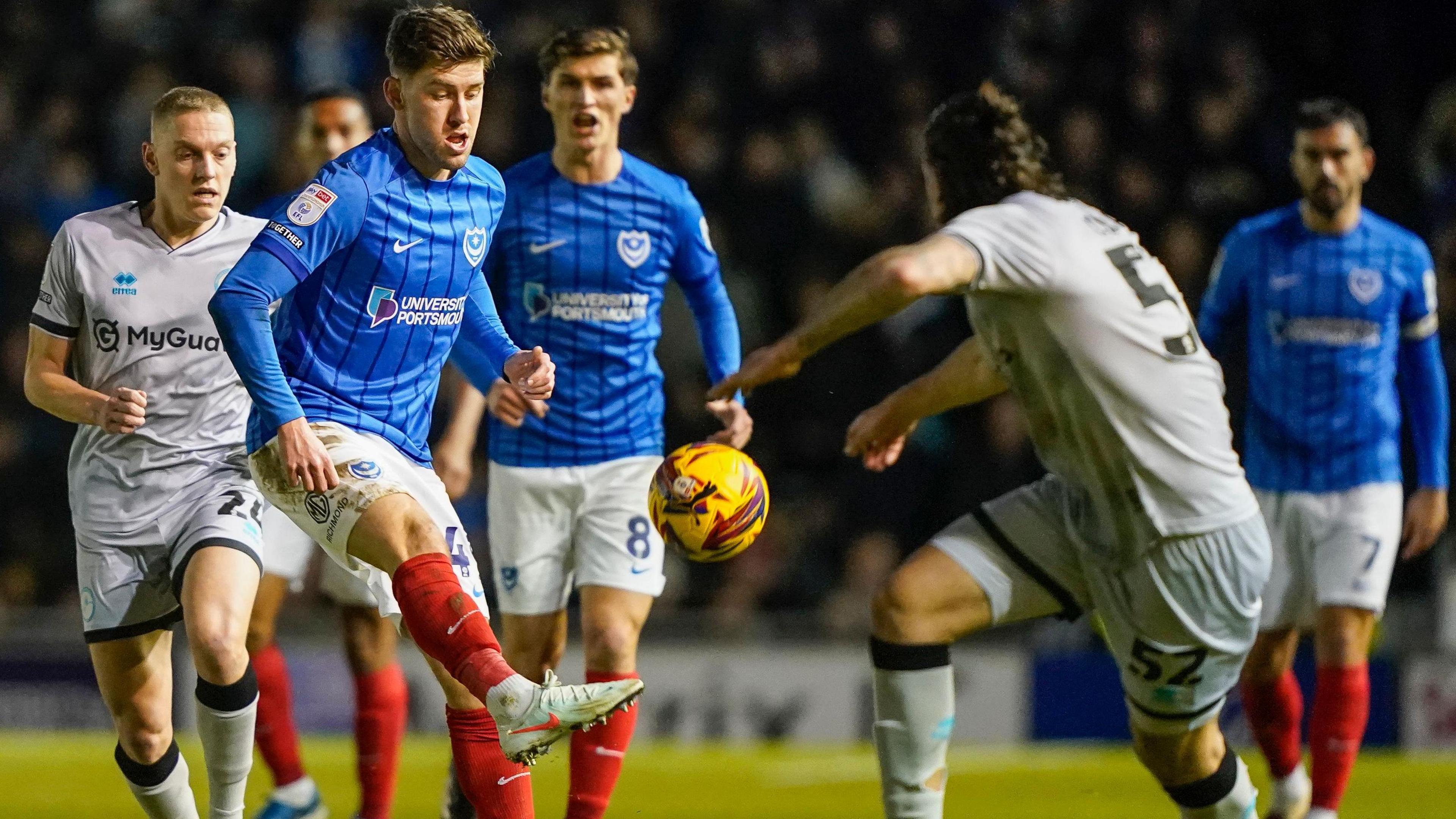 Portsmouth's Callum Lang plays a pass against Millwall