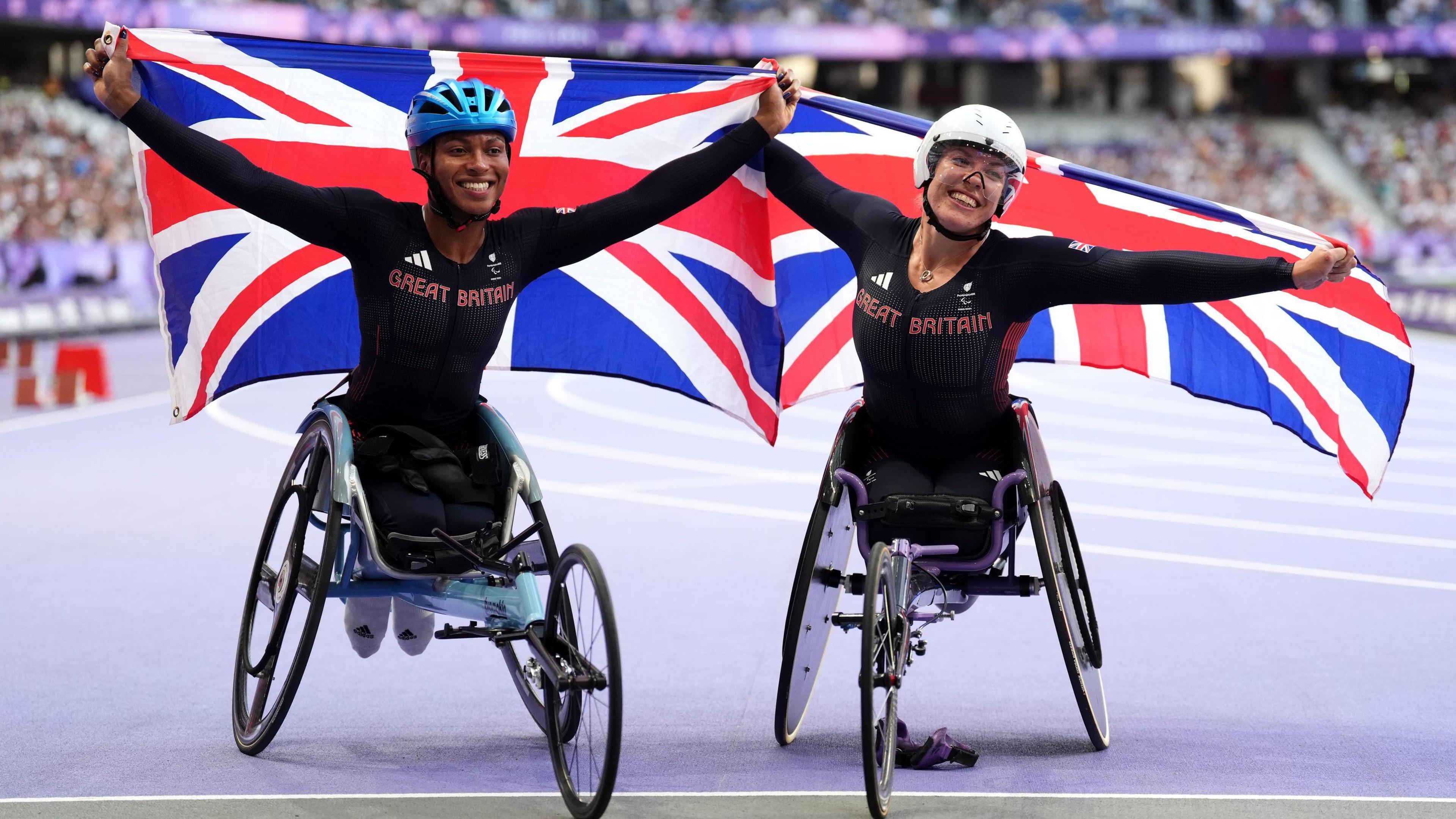 Great Britain's Hannah Cockroft (right) celebrates winning gold and Kare Adenegan celebrates winning silver in the Women's 100m T34 Final