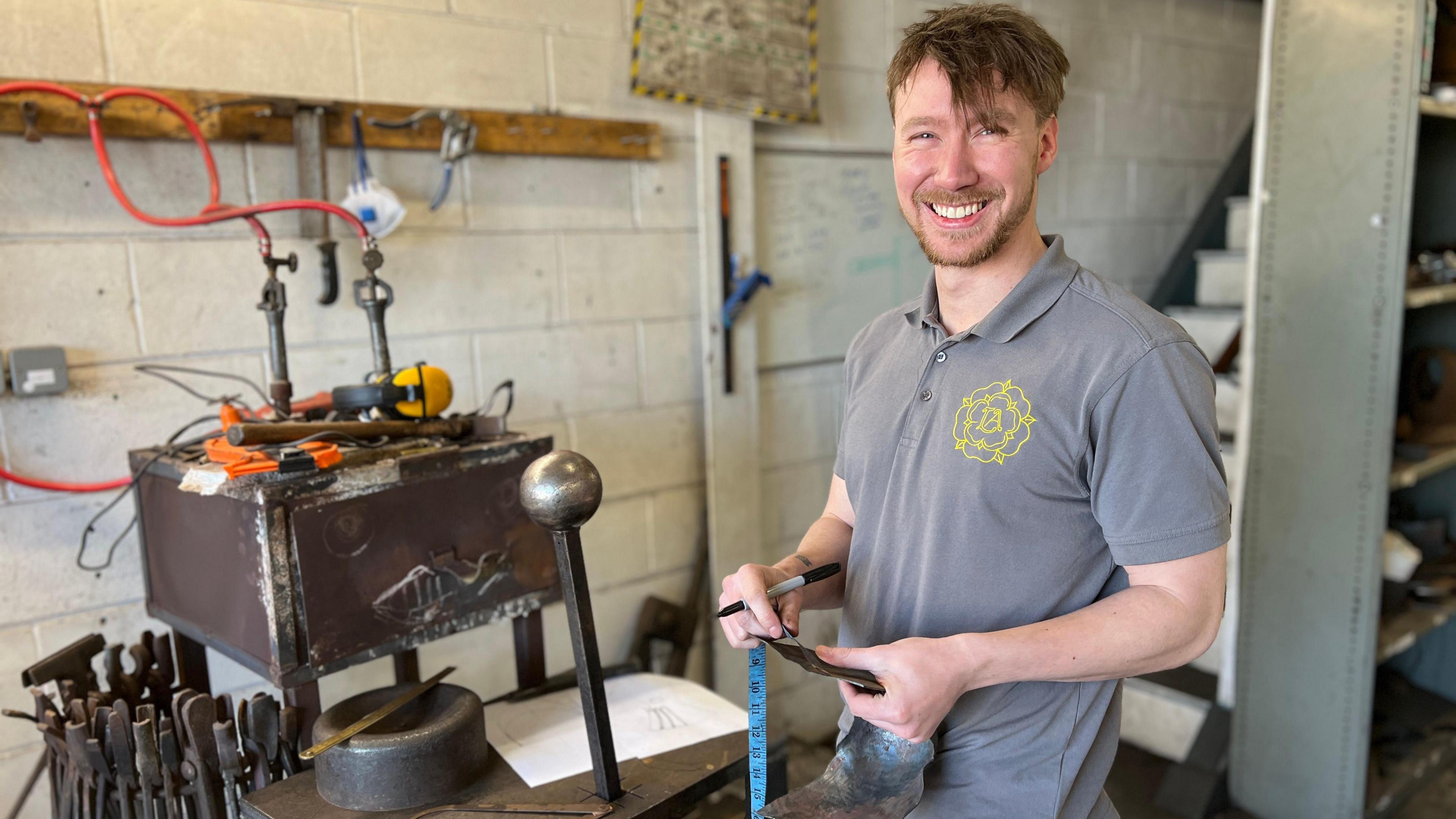 Matt Finchen, stood in his workshop, smiling at the camera