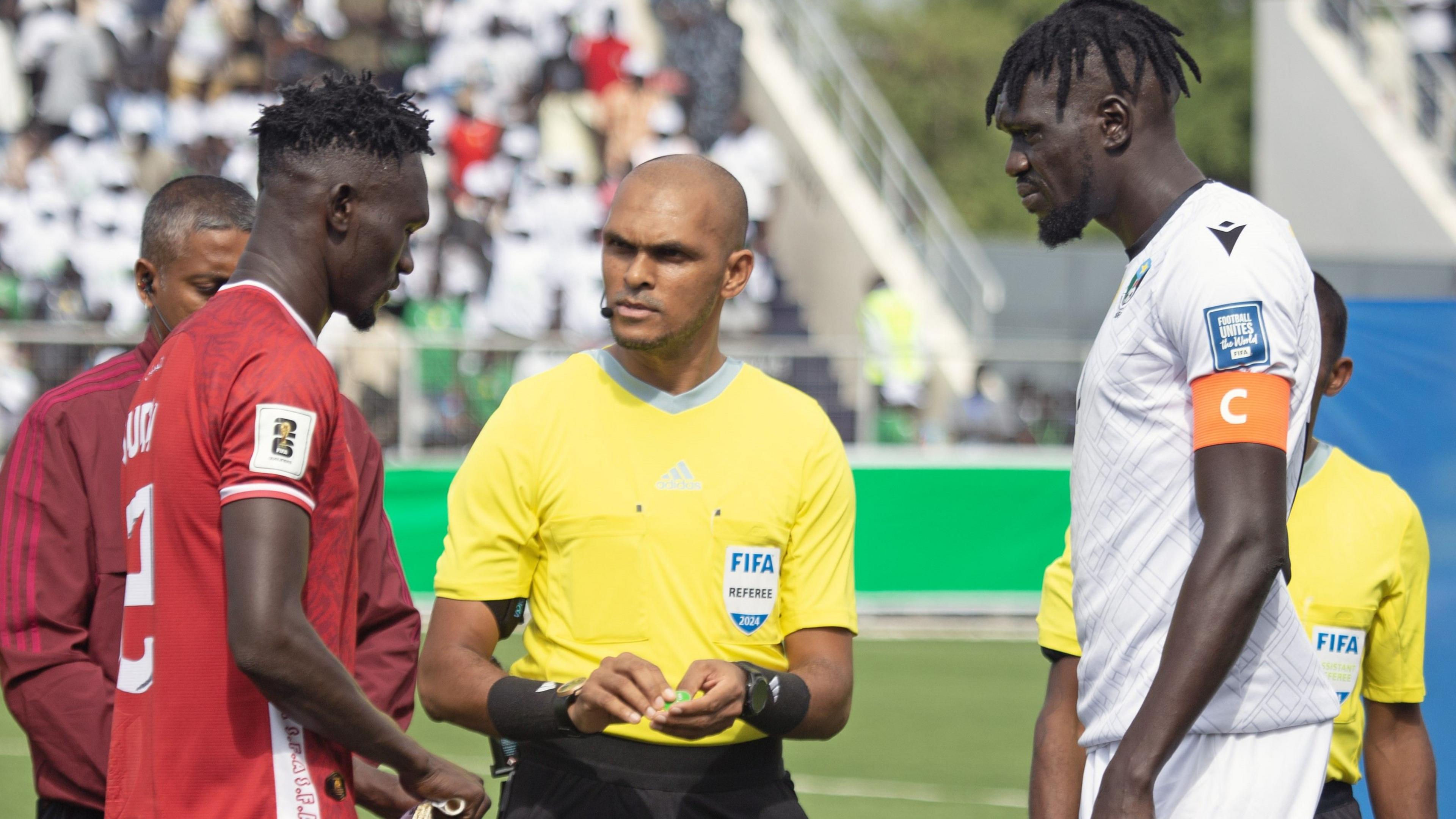 Sudan captain Bakhit Khamis prepares for a coin toss with South Sudan skipper Peter Maker