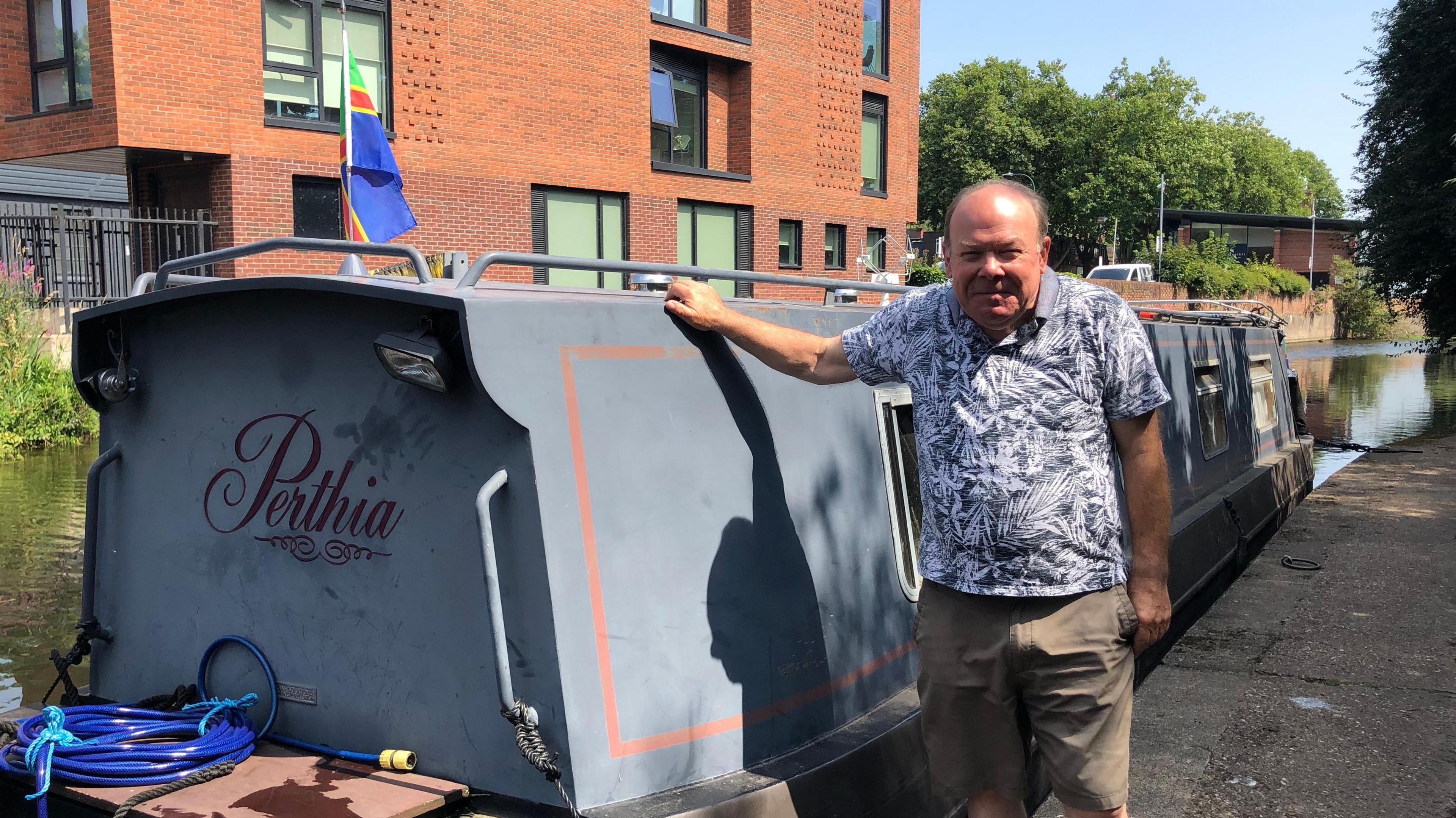 Ian Beswick pictured next to the Parthia canal boat