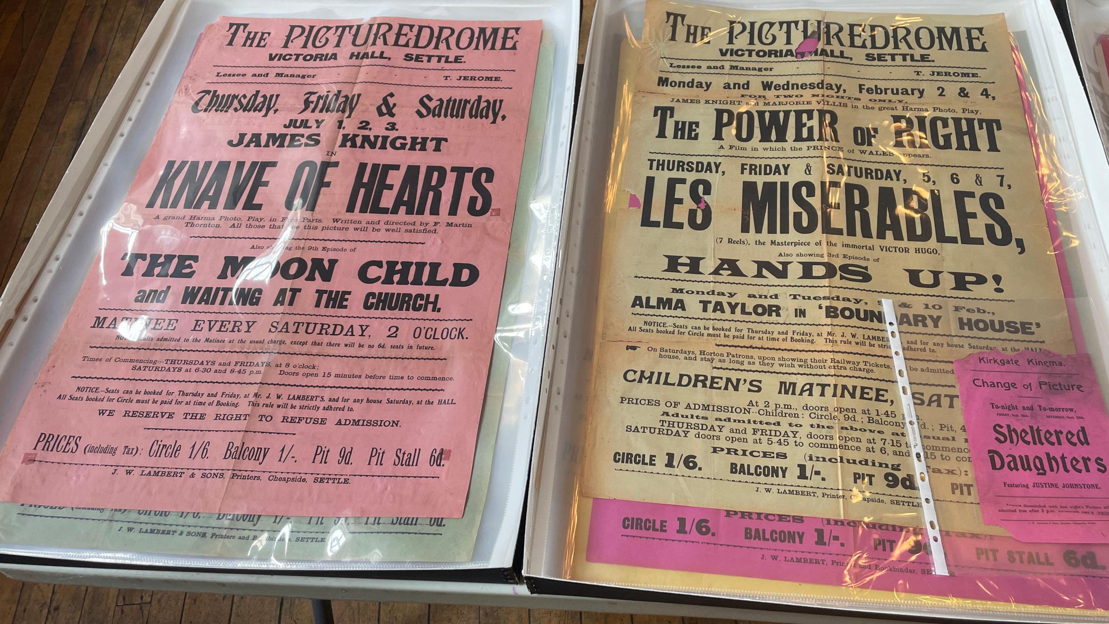 Two cinema posters from the 1920s advertising films at 'The Picturedrome' at Victoria Hall in Settle.

One of the posters is pink whilst the other is yellow. They are both protected by a plastic jacket.

The pink poster is advertising several productions called 'Knave of Hearts', 'The Moon Child' and 'Waiting at the Church'.

The yellow poster is advertising 'The Power of Right', 'Les Miserables' and 'Hands Up!'.