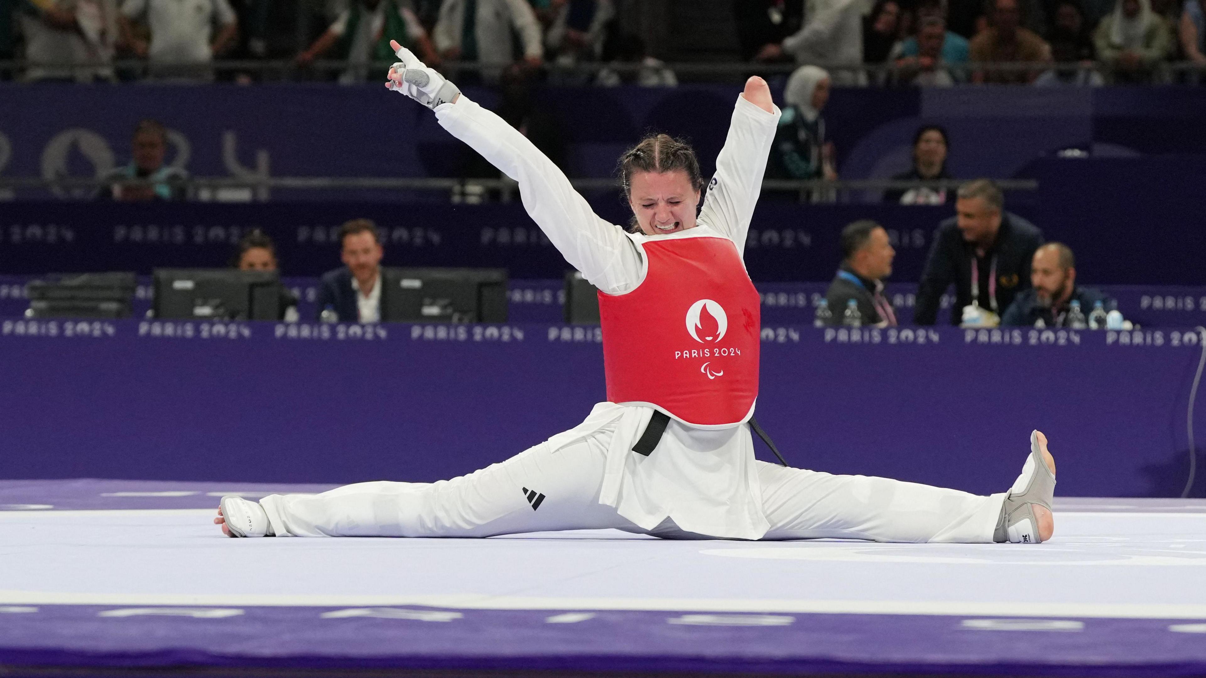 Amy Truesdale of Britain celebrates winning gold after her bout against Guljonoy Naimova of Uzbekistan