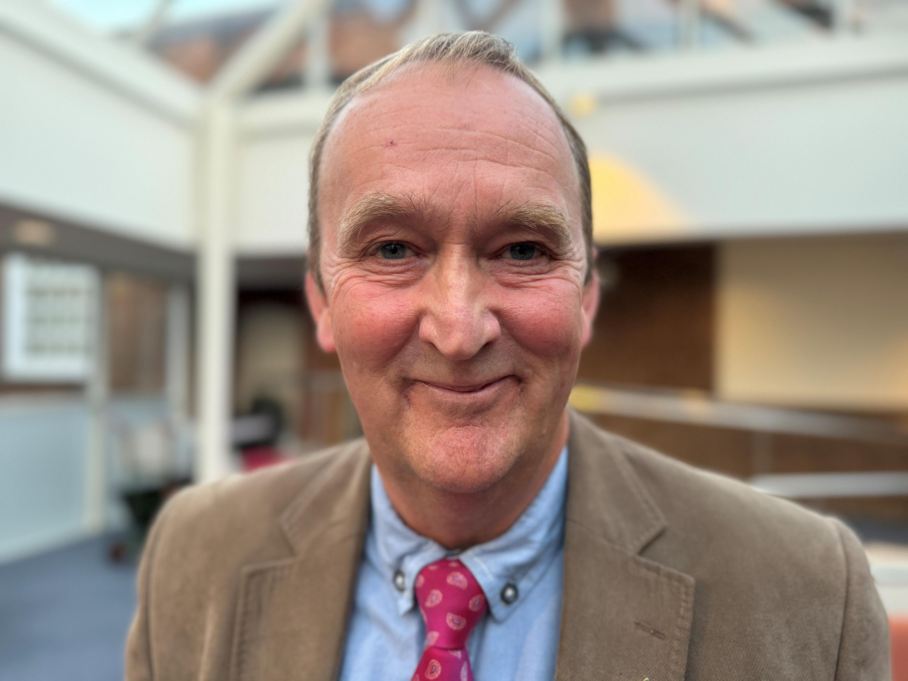 Head and shoulders photograph of council leader Nick Worth