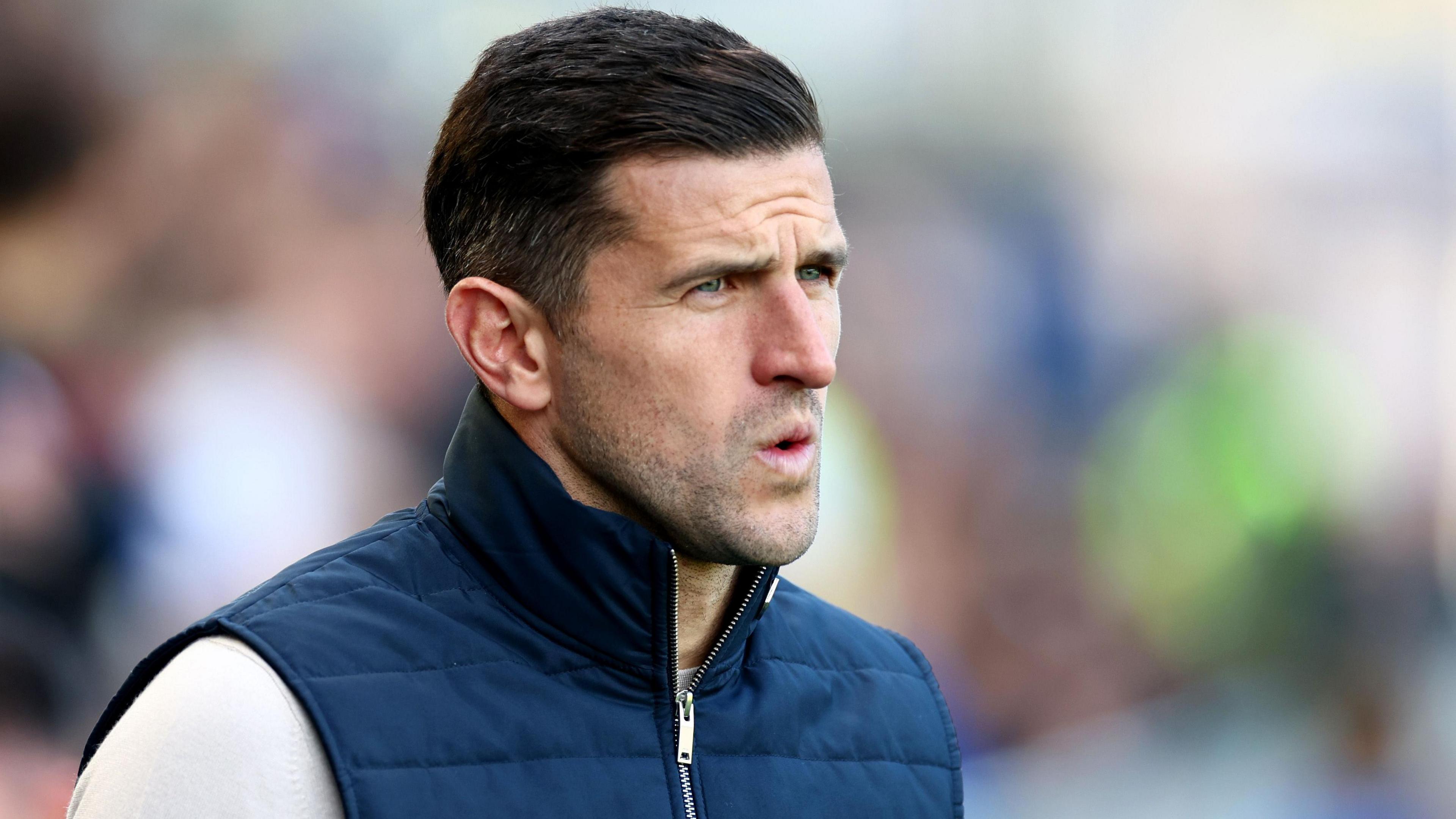 Portsmouth manager John Mousinho looks on