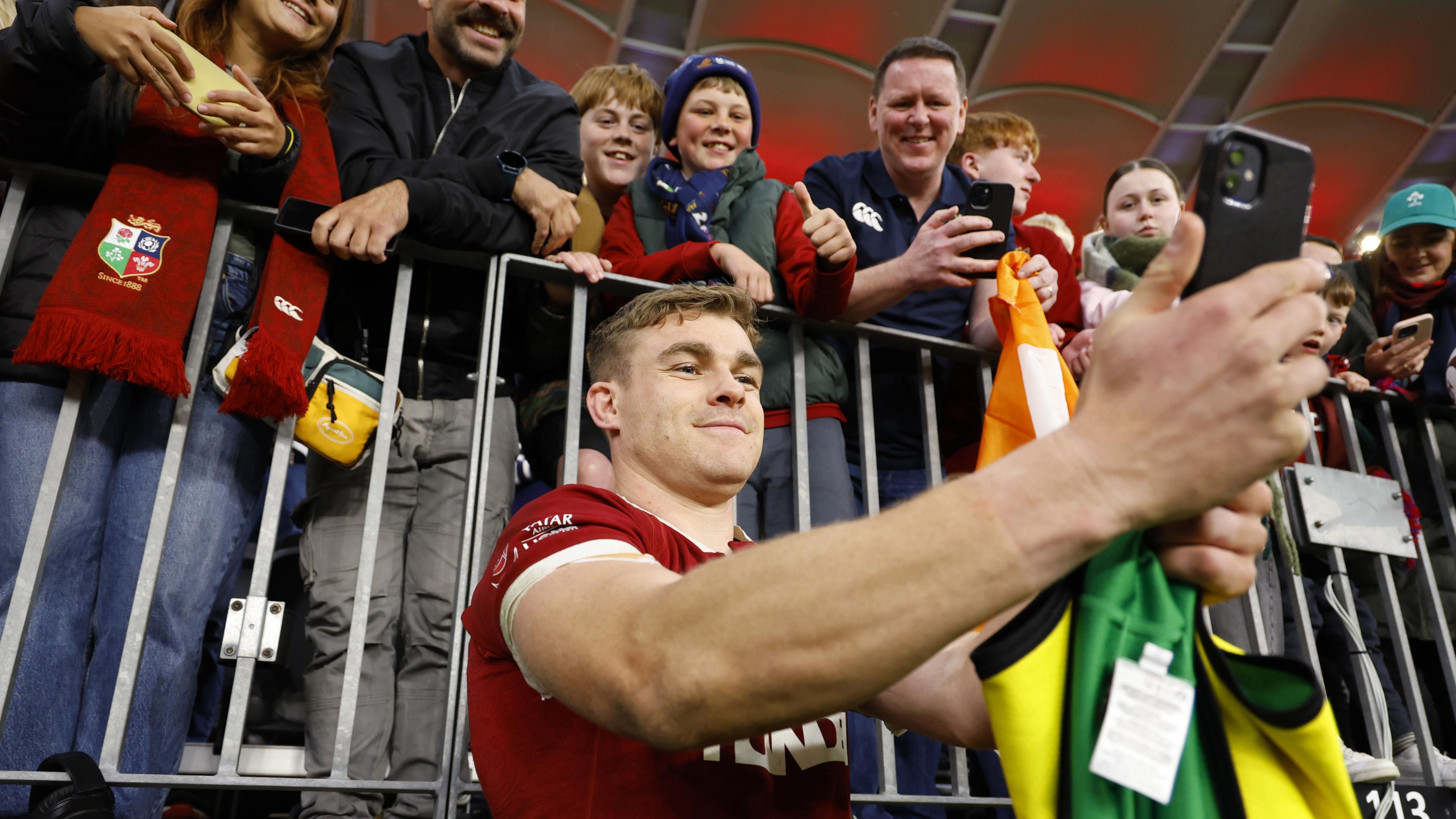 Garry Ringrose takes a selfie with supporters in Perth - he stands in front of a barrier with the fans behind it, above him