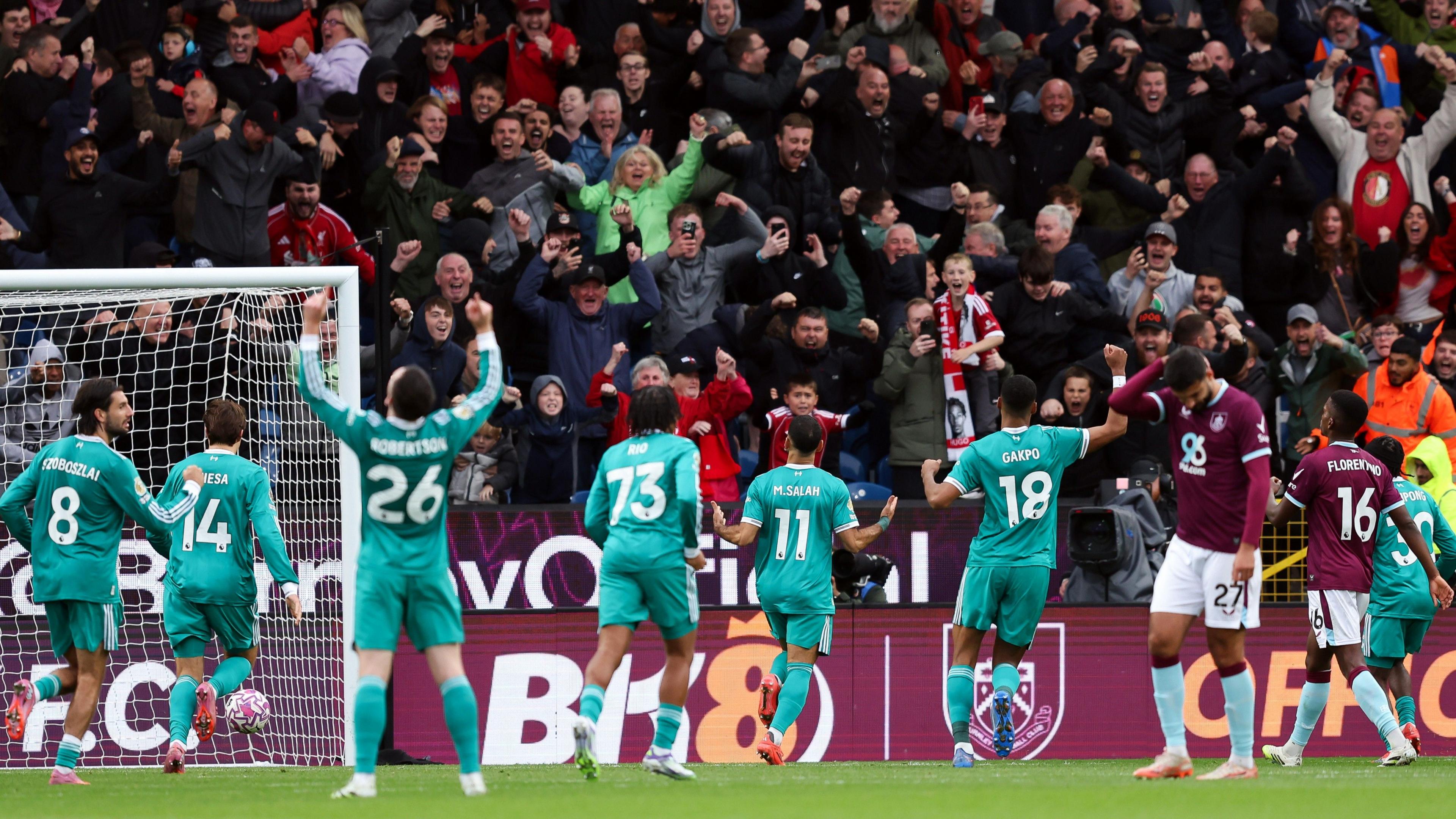 Liverpool players celebrate in front the away end after late winner at Burnley
