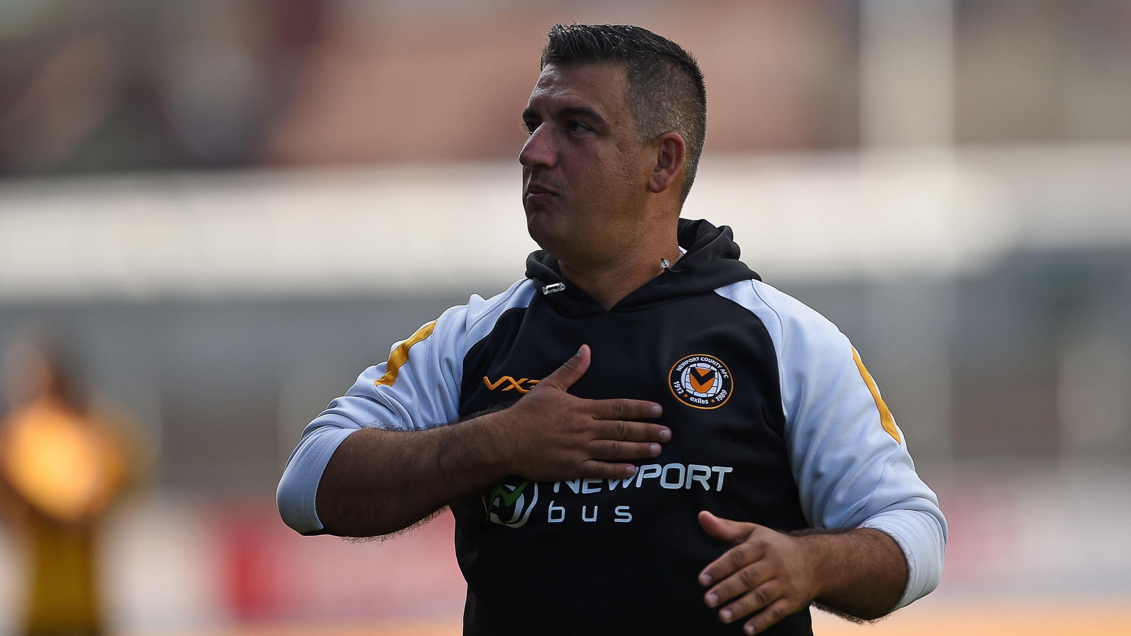 Nelson Jardim slaps his chest in celebration following a Newport County game