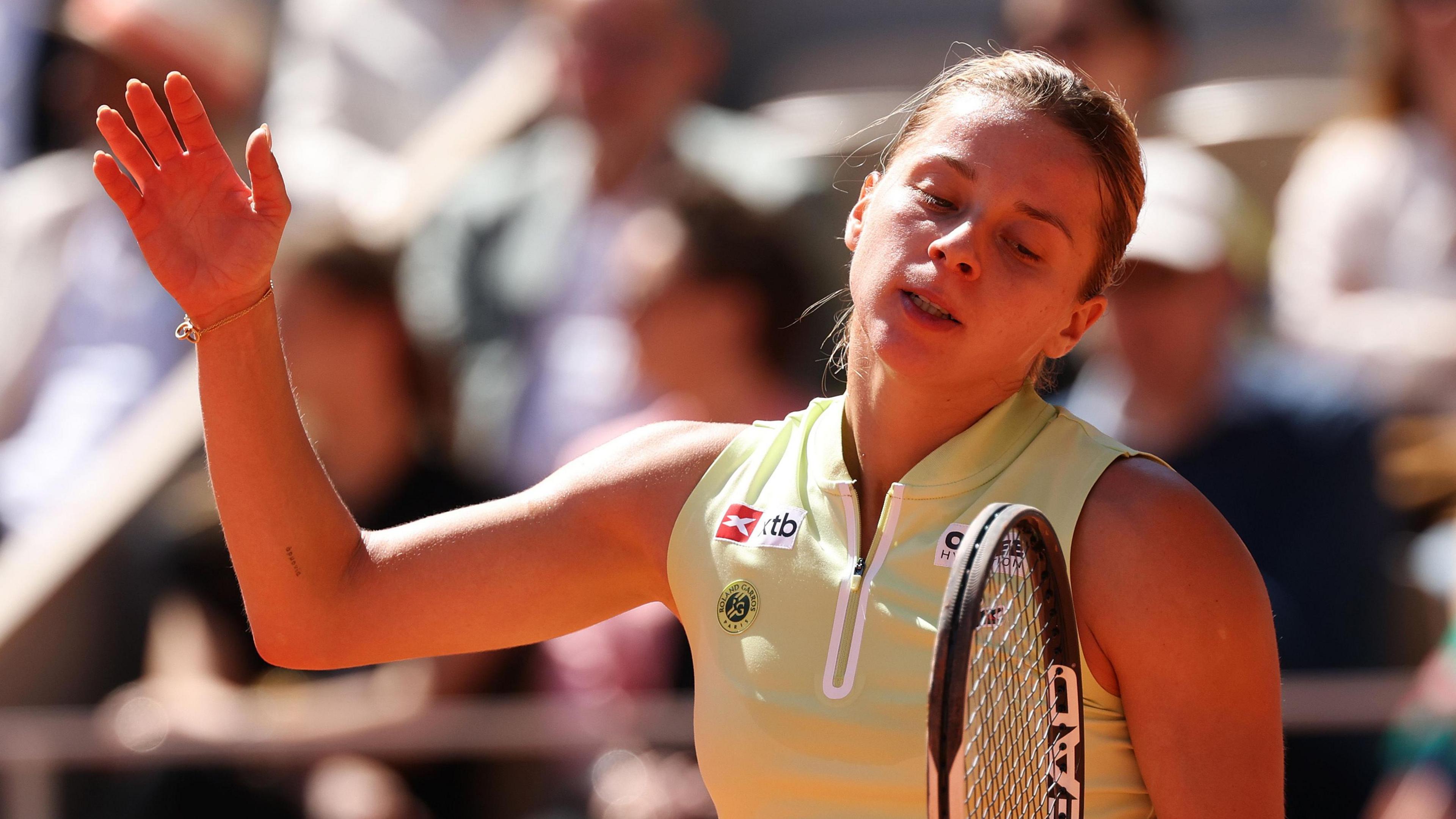 Maja Chwalinska reacts in the French Open final by throwing her right arm into the air
