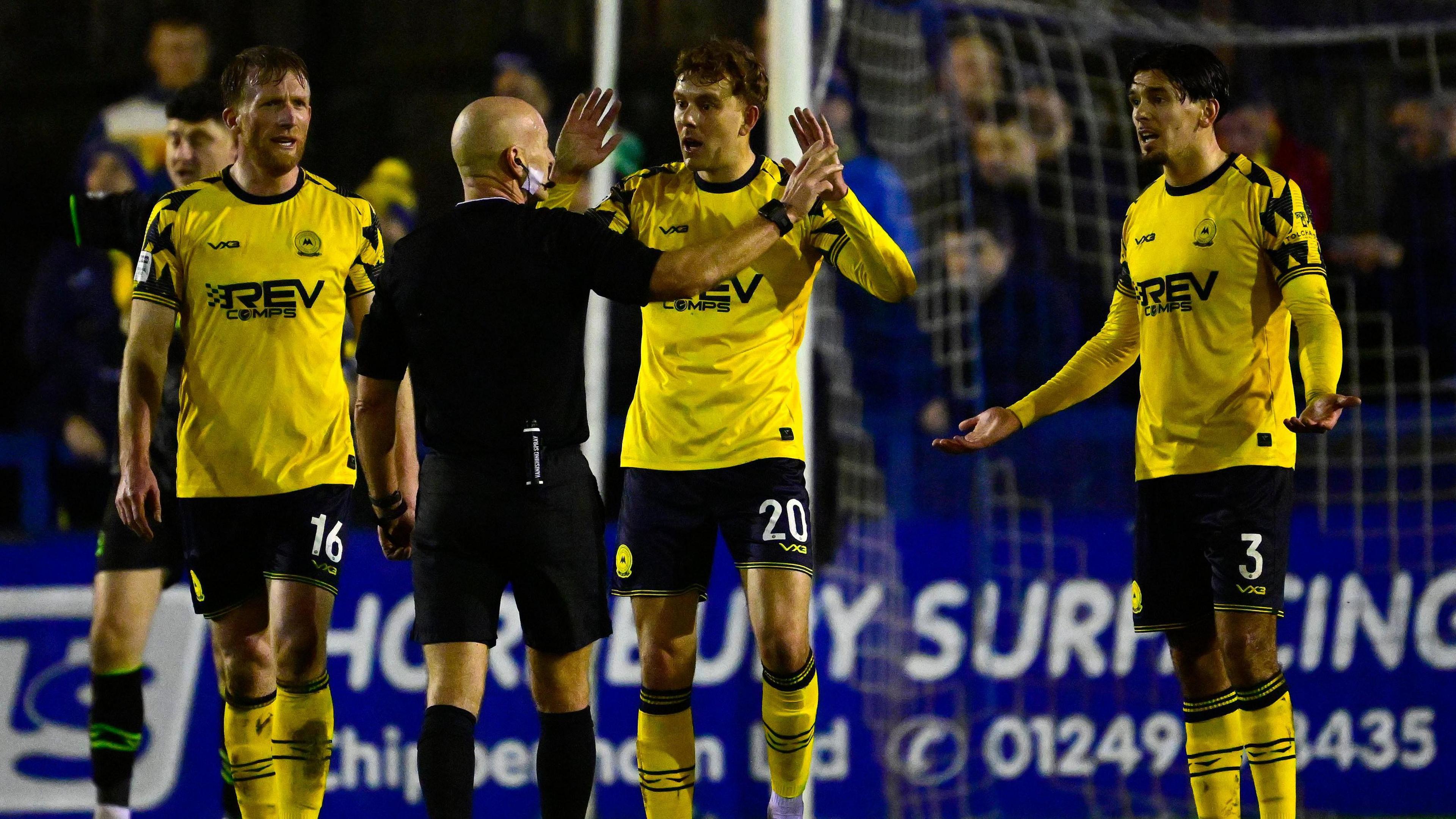 Torquay players remonstrate with the referee at Chippenham Town