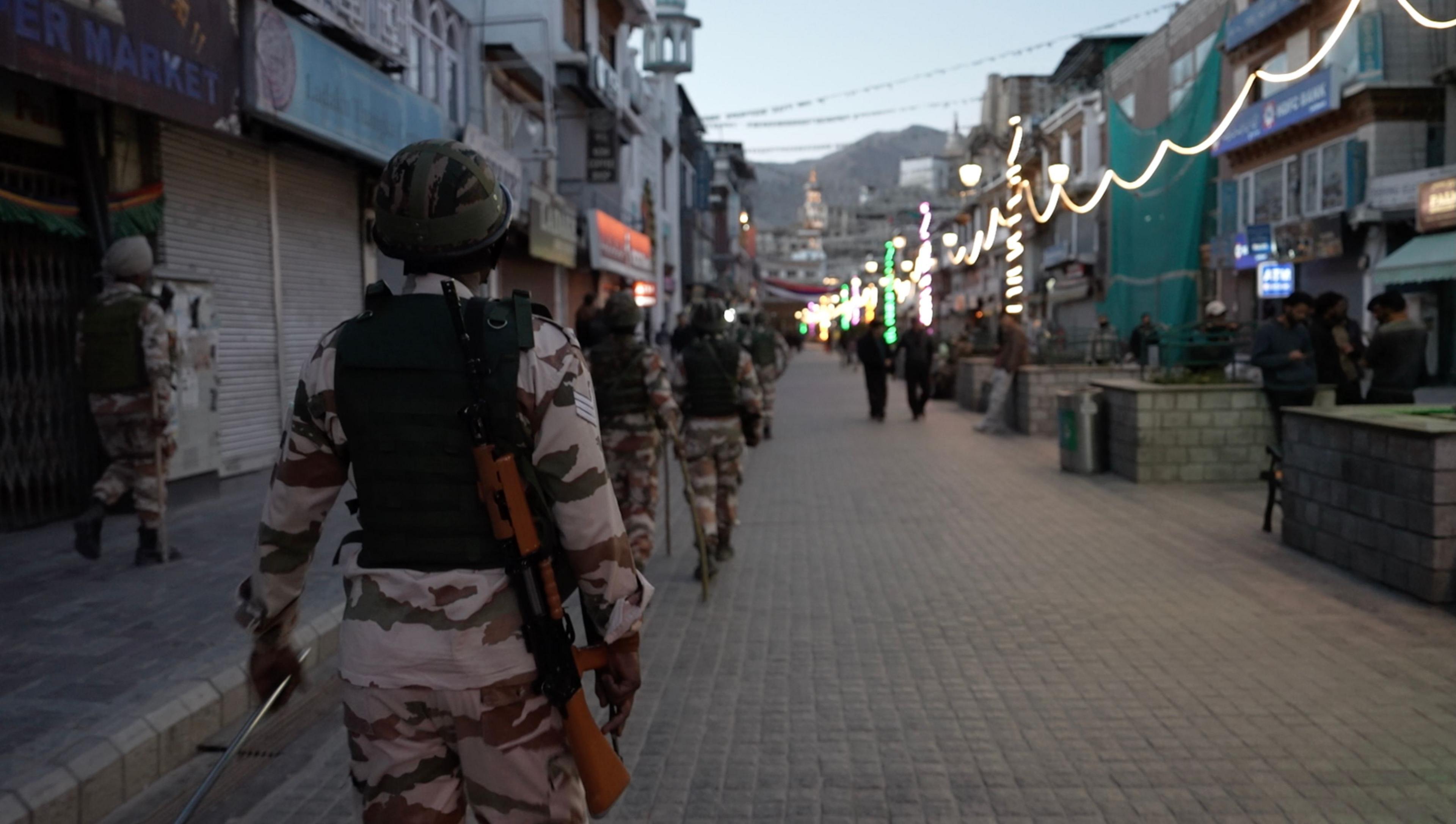 Security personnel stand guard on an otherwise busy street in Ladakh, now almost empty after the protest.