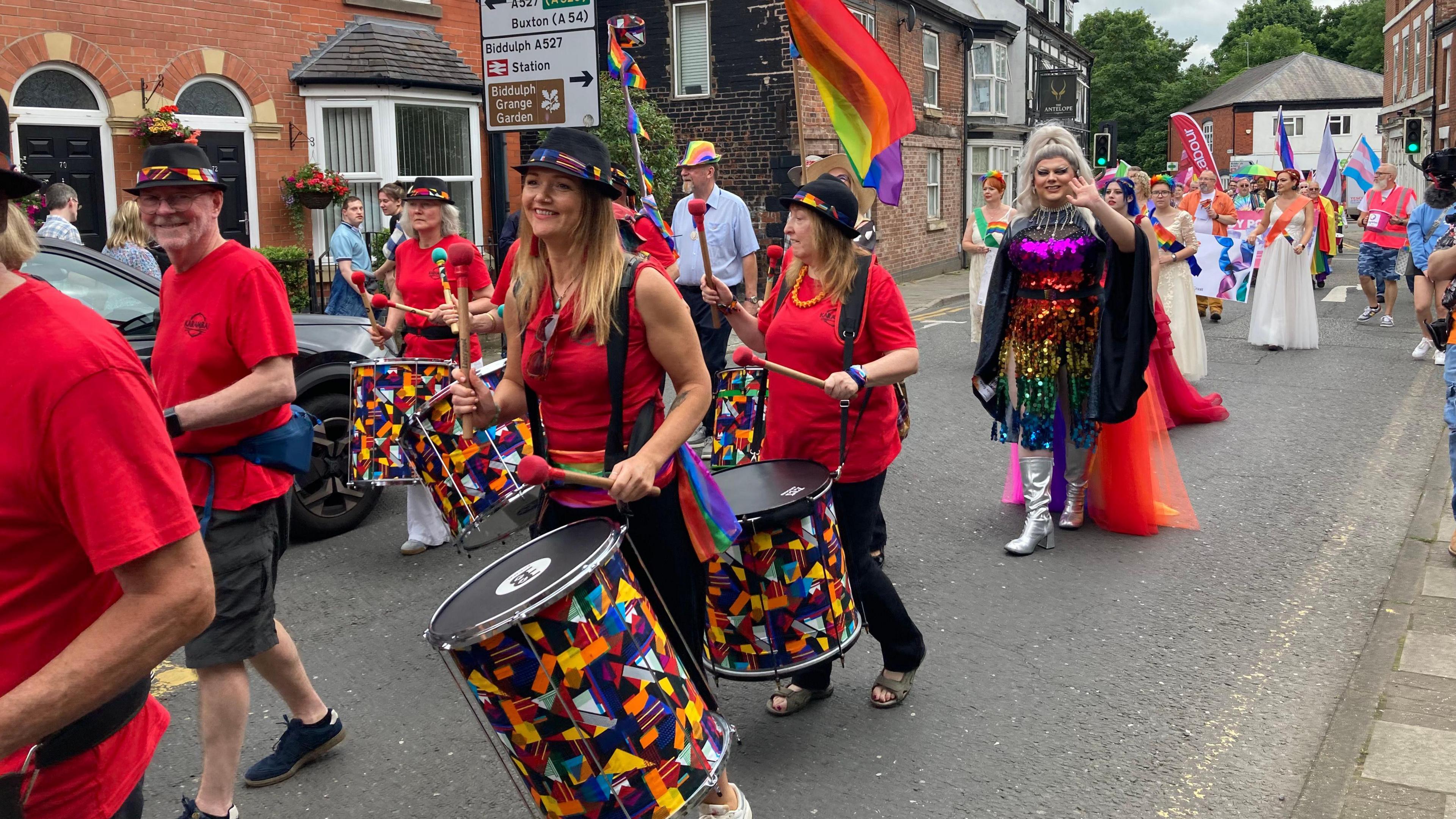 Drummers, drag artists and men and women dressed in colourful clothing for Congleton Pride