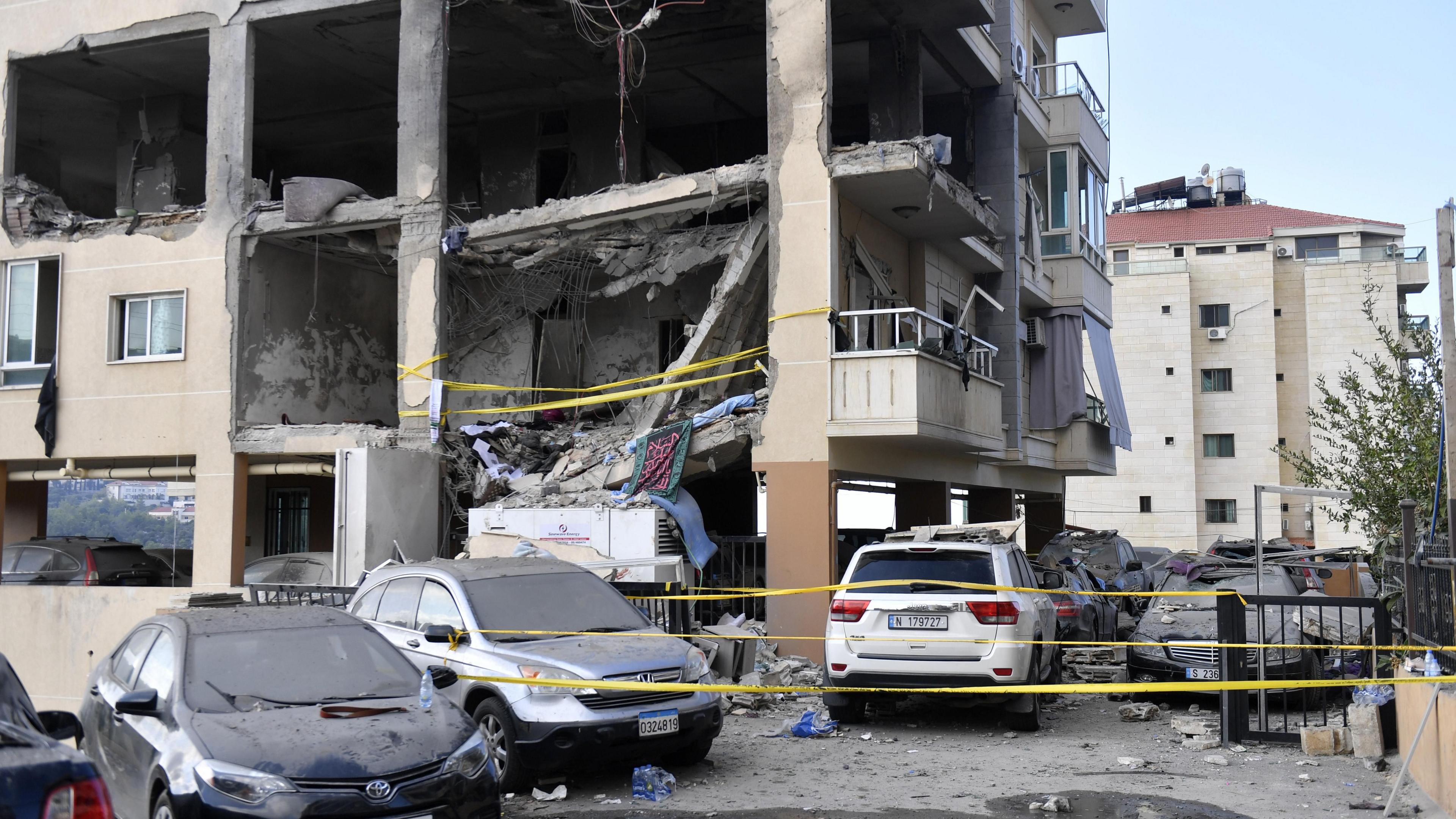 Damaged multi-storey residential building and cars following an Israeli air strike in Aramoun, Lebanon (13 November 2024)