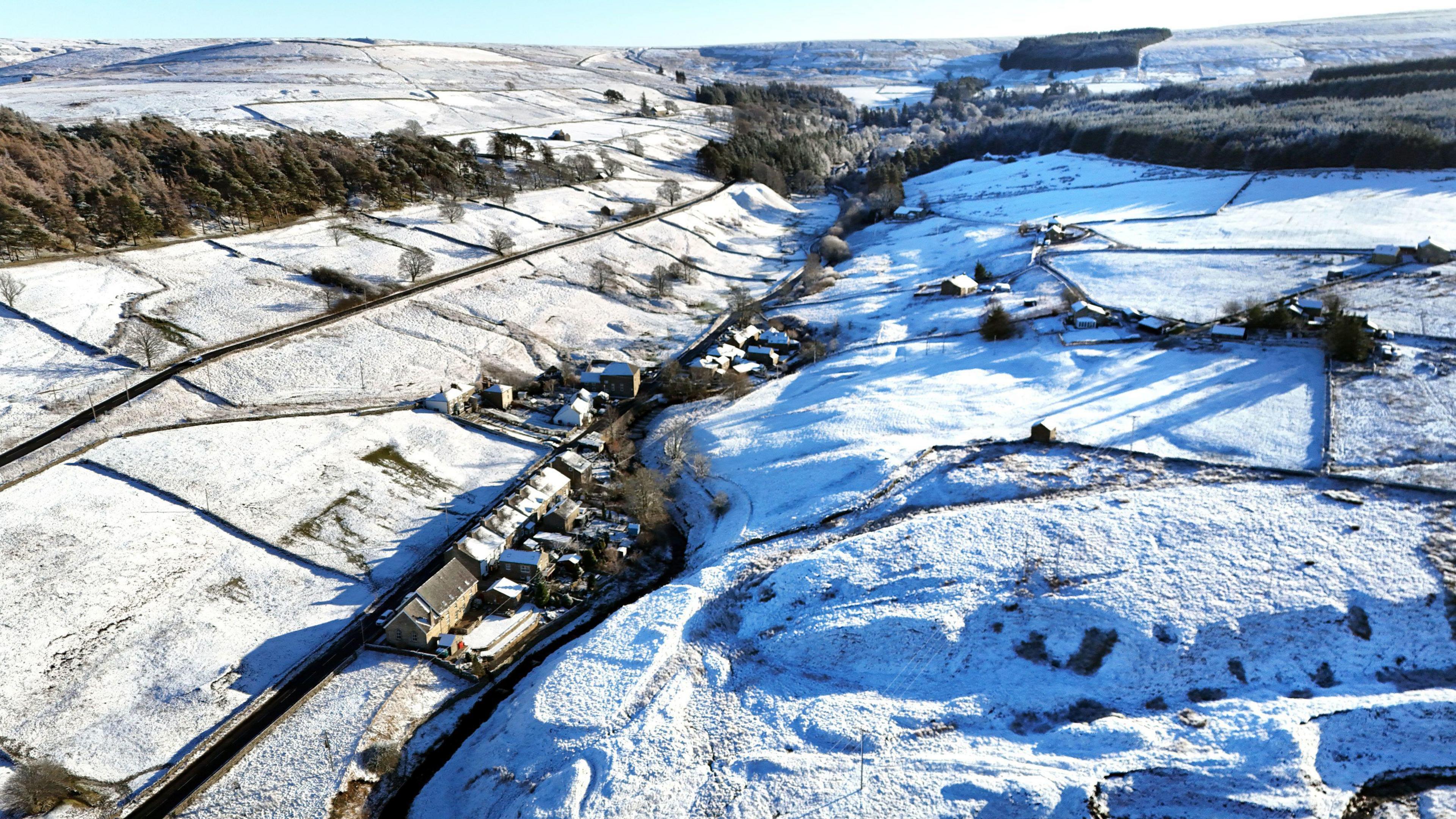 Snow in fields in Northumberland, landscape seen from the air.