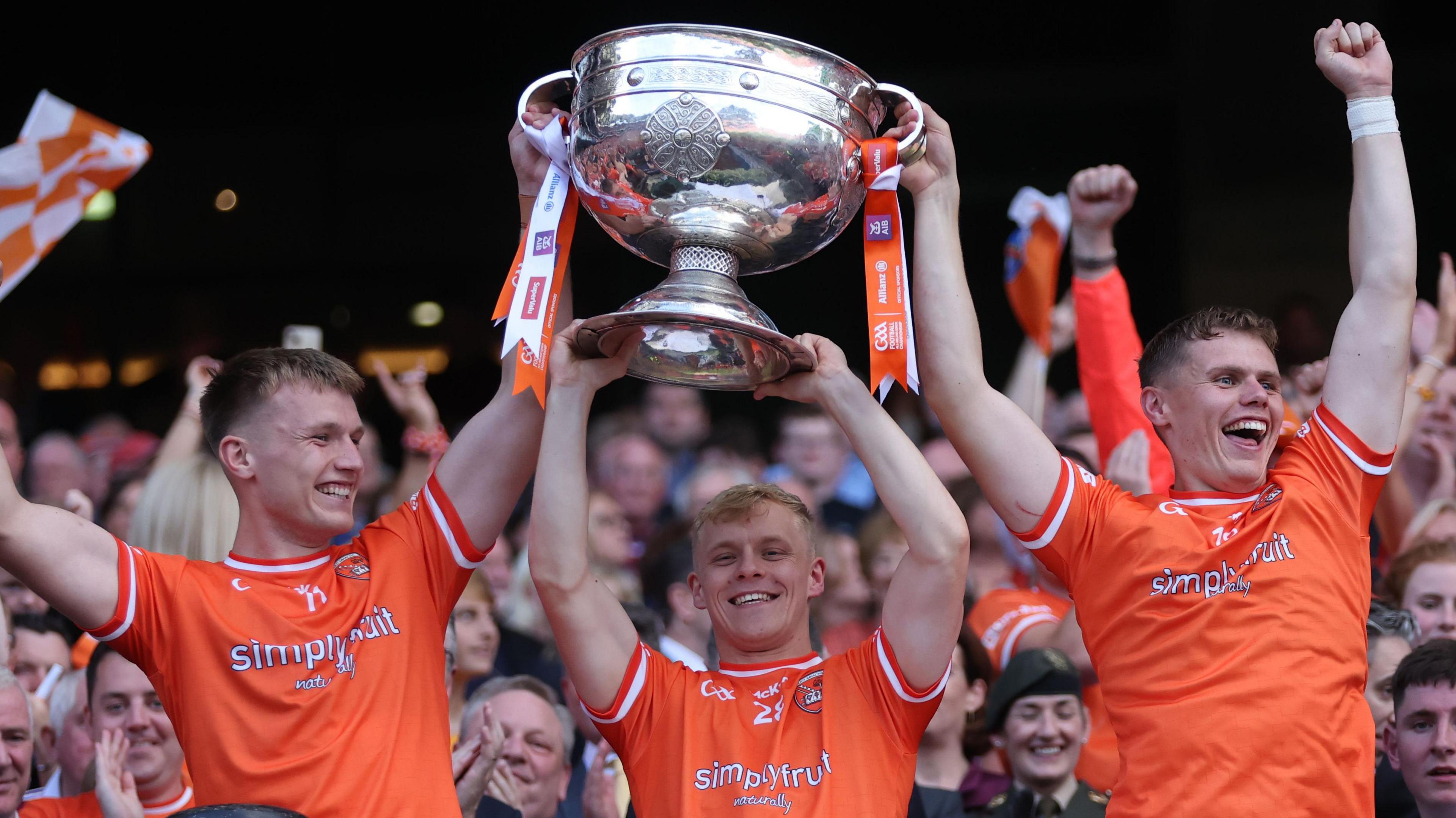 Armagh players celebrate their All-Ireland success in July by lifting the Sam Maguire trophy