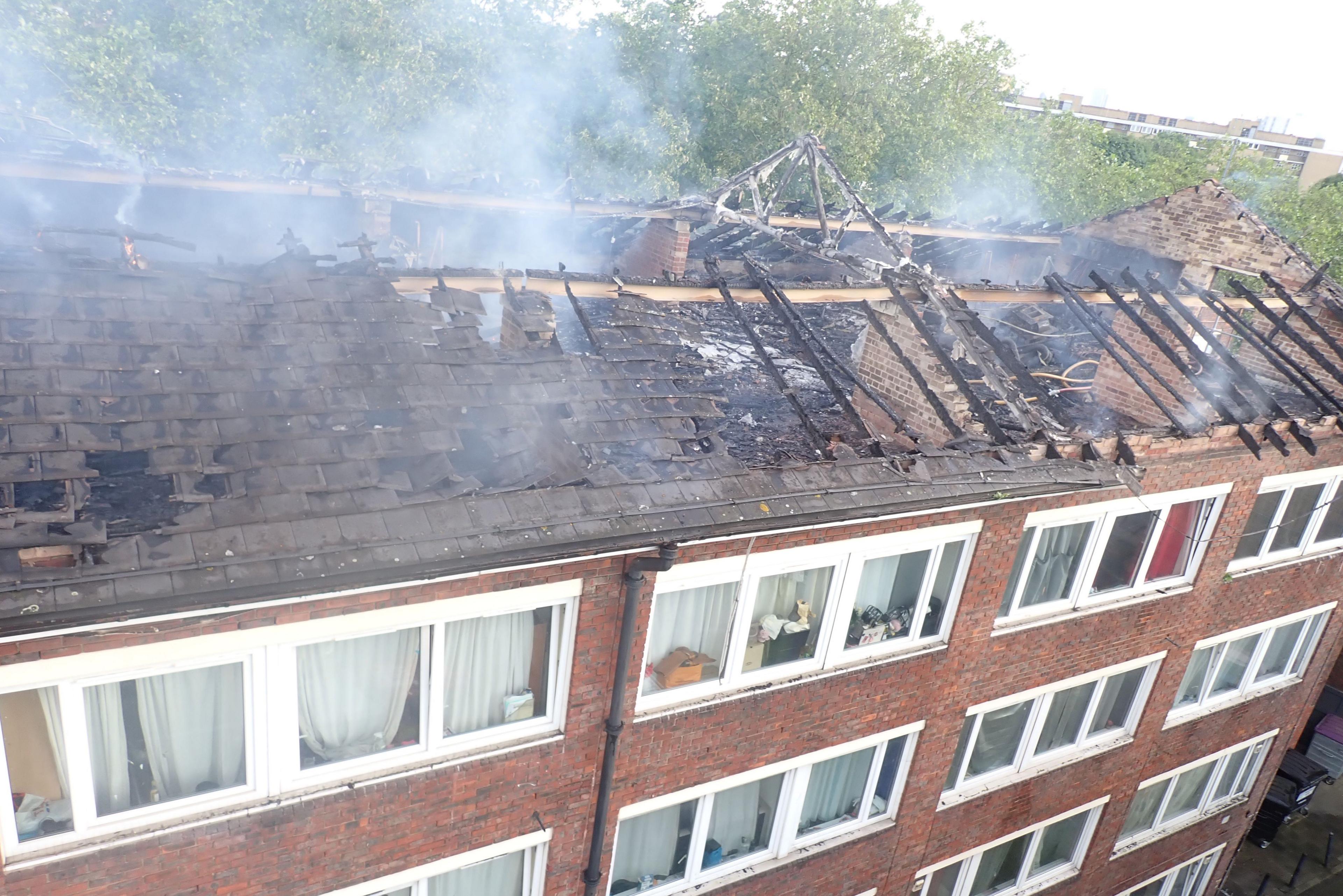 Smoke rises from roof of Dalston Lane flats