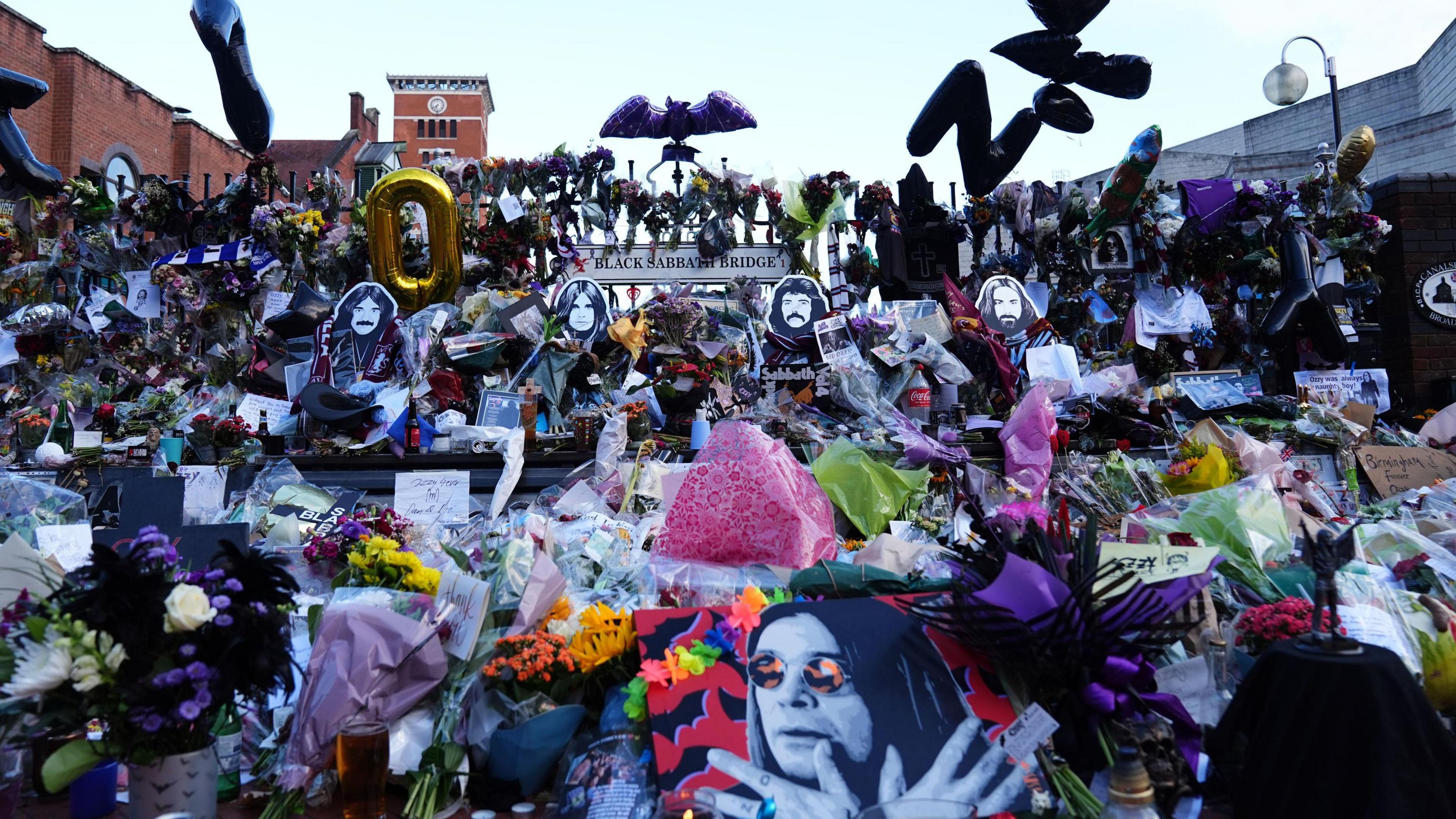 Floral tributes left at the Black Sabbath Bridge bench on Broad Street in Birmingham in memory of Black Sabbath frontman Ozzy Osbourne
